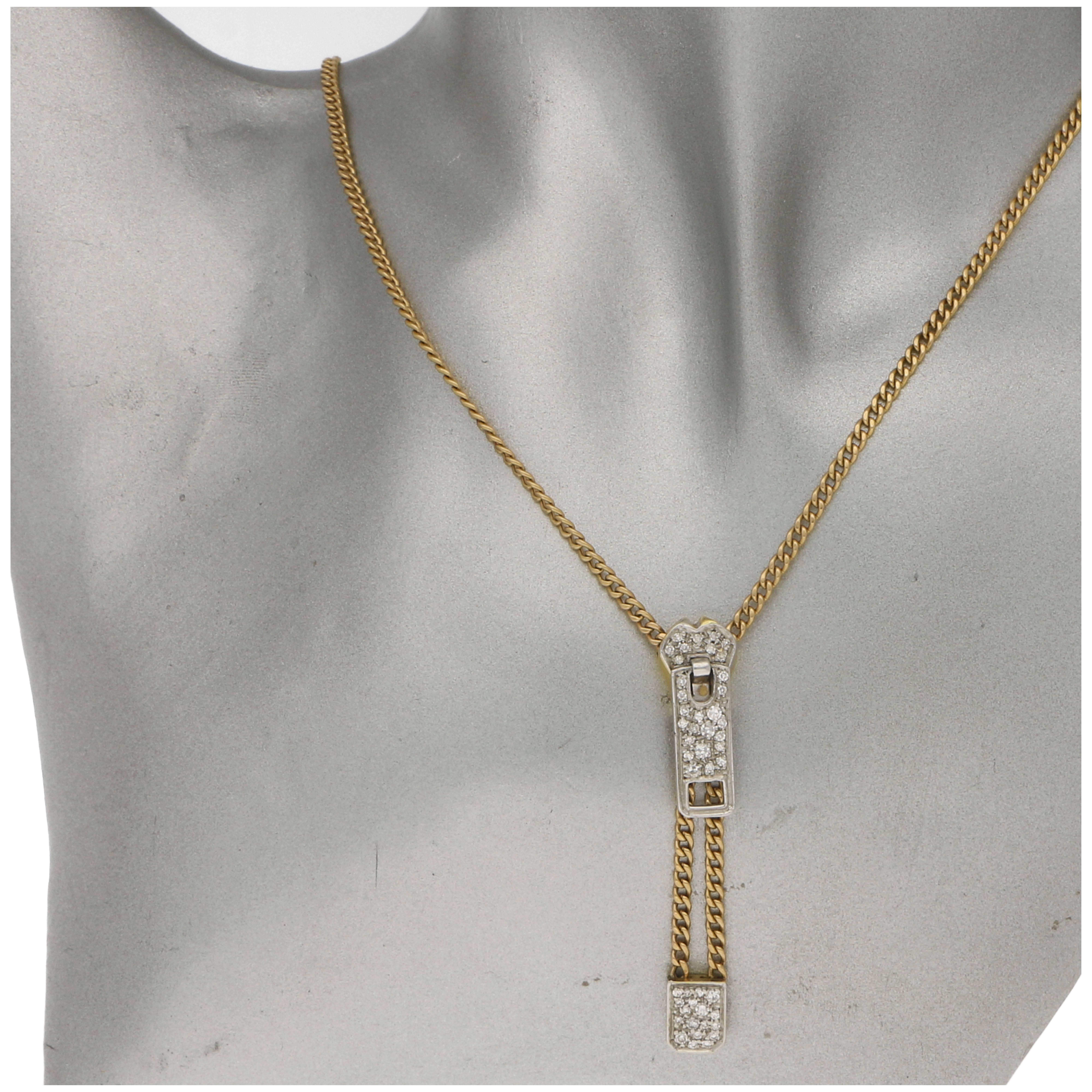 Estimated total diamond weight: 0.41 carats.
A fabulously quirky zipper necklace. 
The necklace is formed of a curb link chain in 14 carat yellow gold and is fitted with a working diamond set zip motif that runs up and down the chain and can be