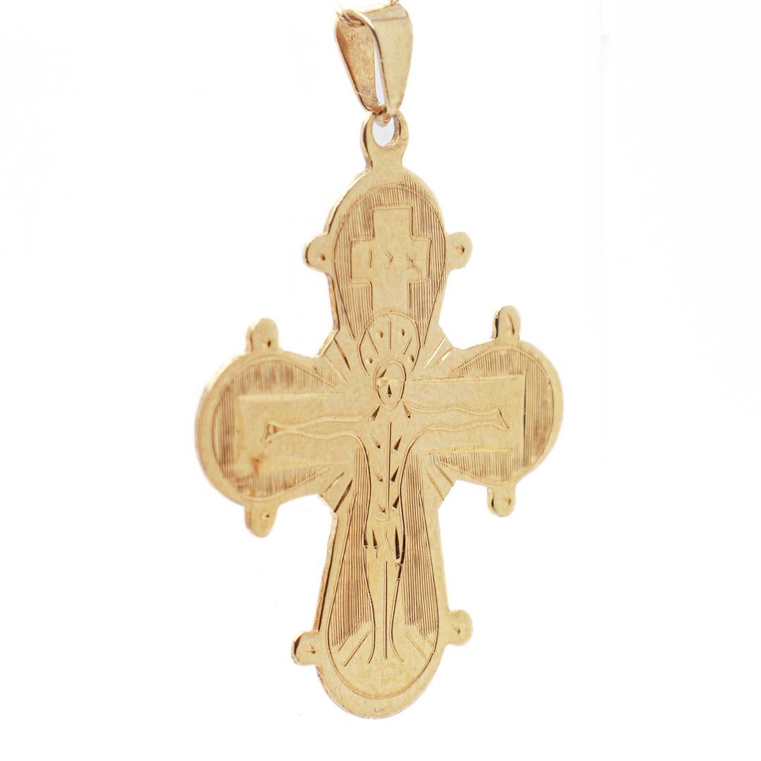 A fine antique pendant cross.

In 14k gold.

With an Eastern Orthodox depiction of Christ on the cross to the front and a group of saints to the reverse.

Simply a wonderful crucifix pendant!

Date:
Late 20th Century

Overall Condition:
It is in