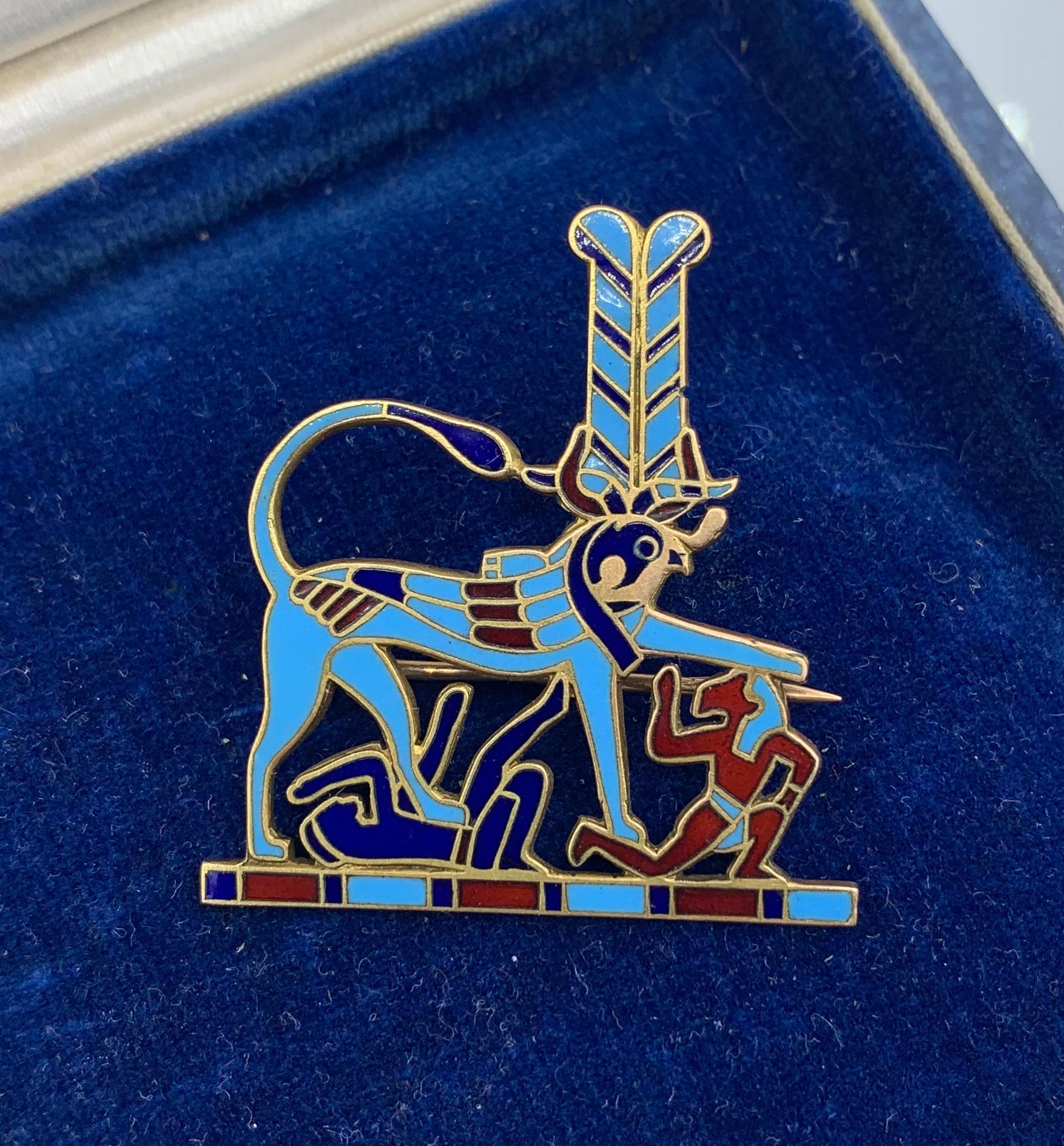 This is a rare Art Deco Egyptian Revival 14 Karat Gold and Enamel Brooch depicting Heremakhet (Greek: Harmakhis).  Heremakhet is a Hieracosphinx who has the body of a lion and the head of falcon and is representative of the god Horus.  It is related