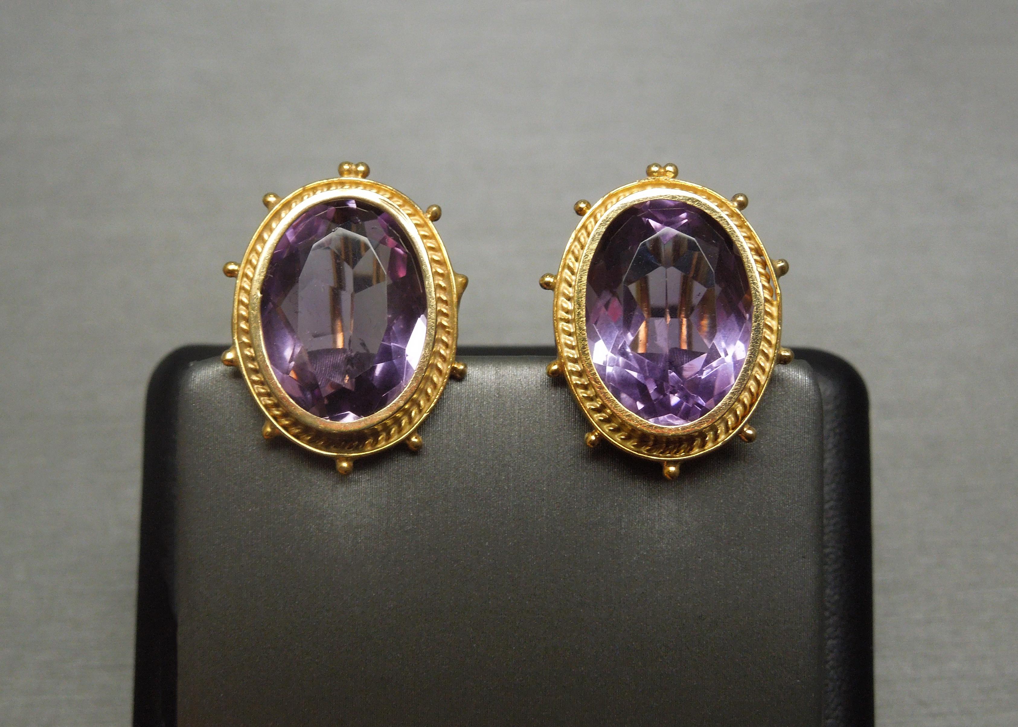 Antique Victorian Circa 1890
in an Etruscan / Revival Inspired design

Constructed completely of 14 Karat Yellow Gold

Each containing 1 Bezel set Genuine Earth-Mined Faceted Oval cut Natural Intense Purple Amethyst
totaling approximately 30.00