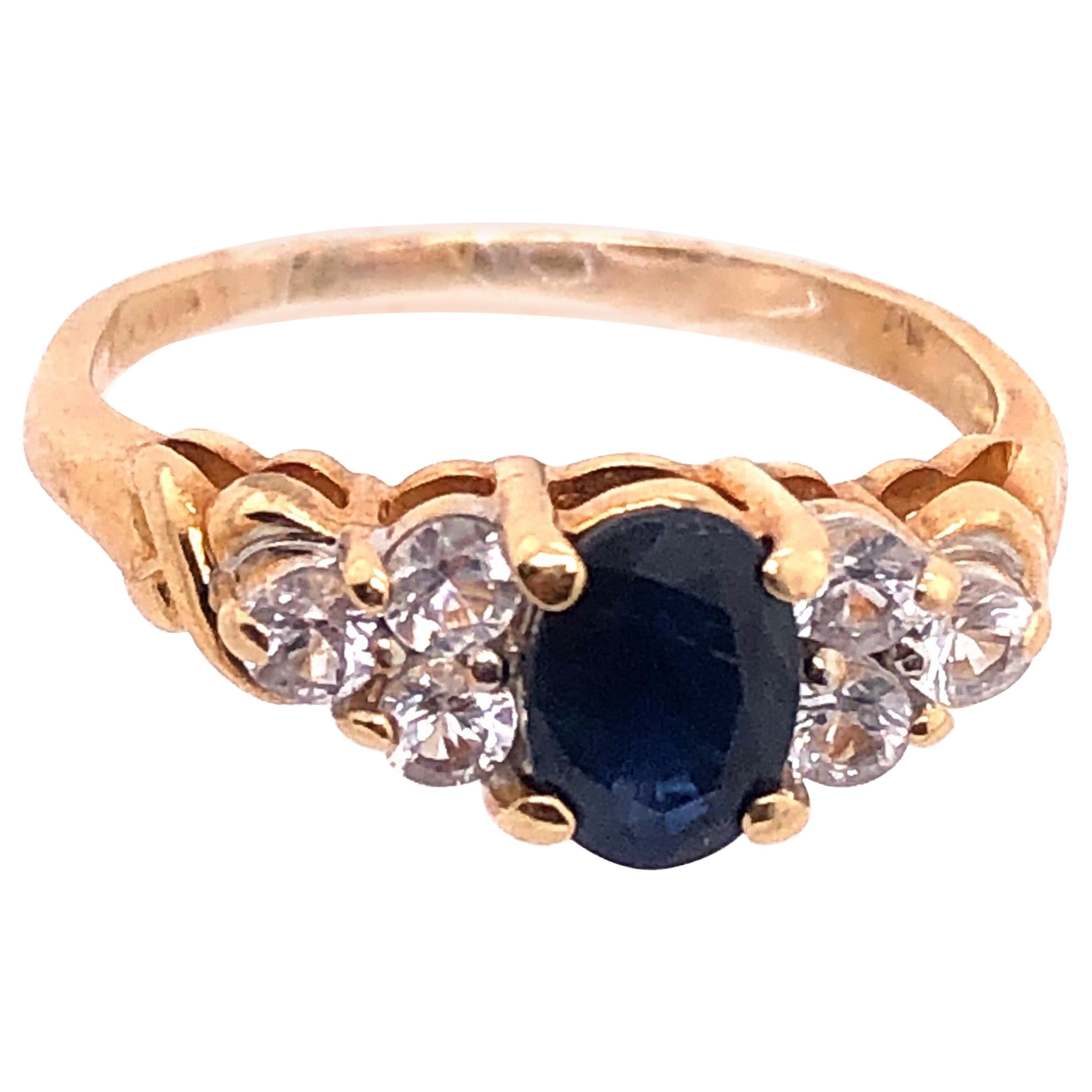 14 Karat Gold Fashion Ring Center Oval Sapphire and Diamond Accent 0.50 TDW