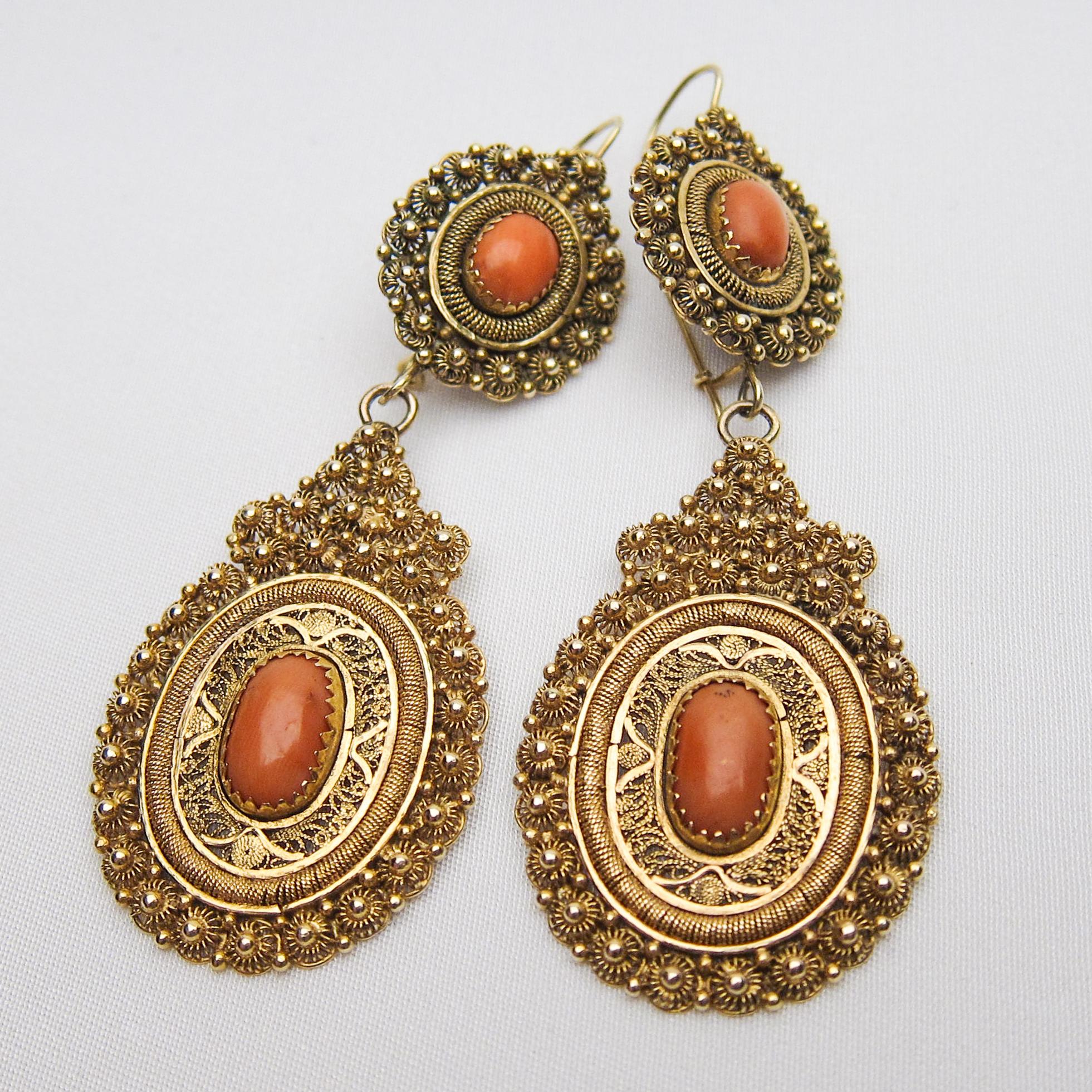  These amazing  handmade earrings feature orange coral cabochons set in fabulously ornamental 14KT gold settings. These stunning pieces articulate the beauty and grace of Victorian craftsmanship.