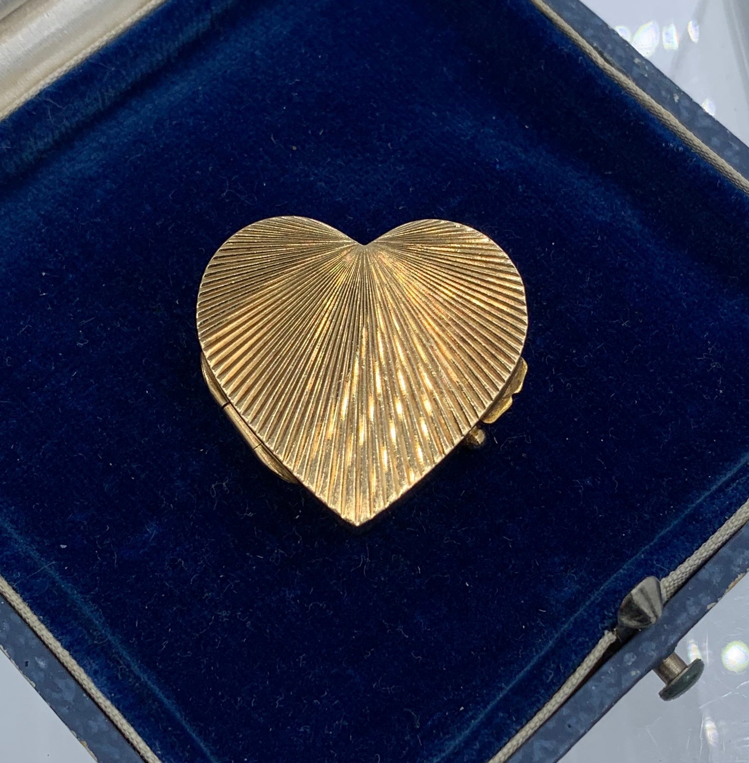 THIS IS A WONDERFUL ANTIQUE SOLID 14 KARAT YELLOW GOLD HEART SHAPE BOX WITH AN ENGINE TURNED RADIATING RAYS DESIGN.   THE 14K GOLD BOX IS PERFECT FOR YOUR TREASURED JEWELRY, KEEPSAKES, OR PILLS.
We are so thrilled to have found the most elegant