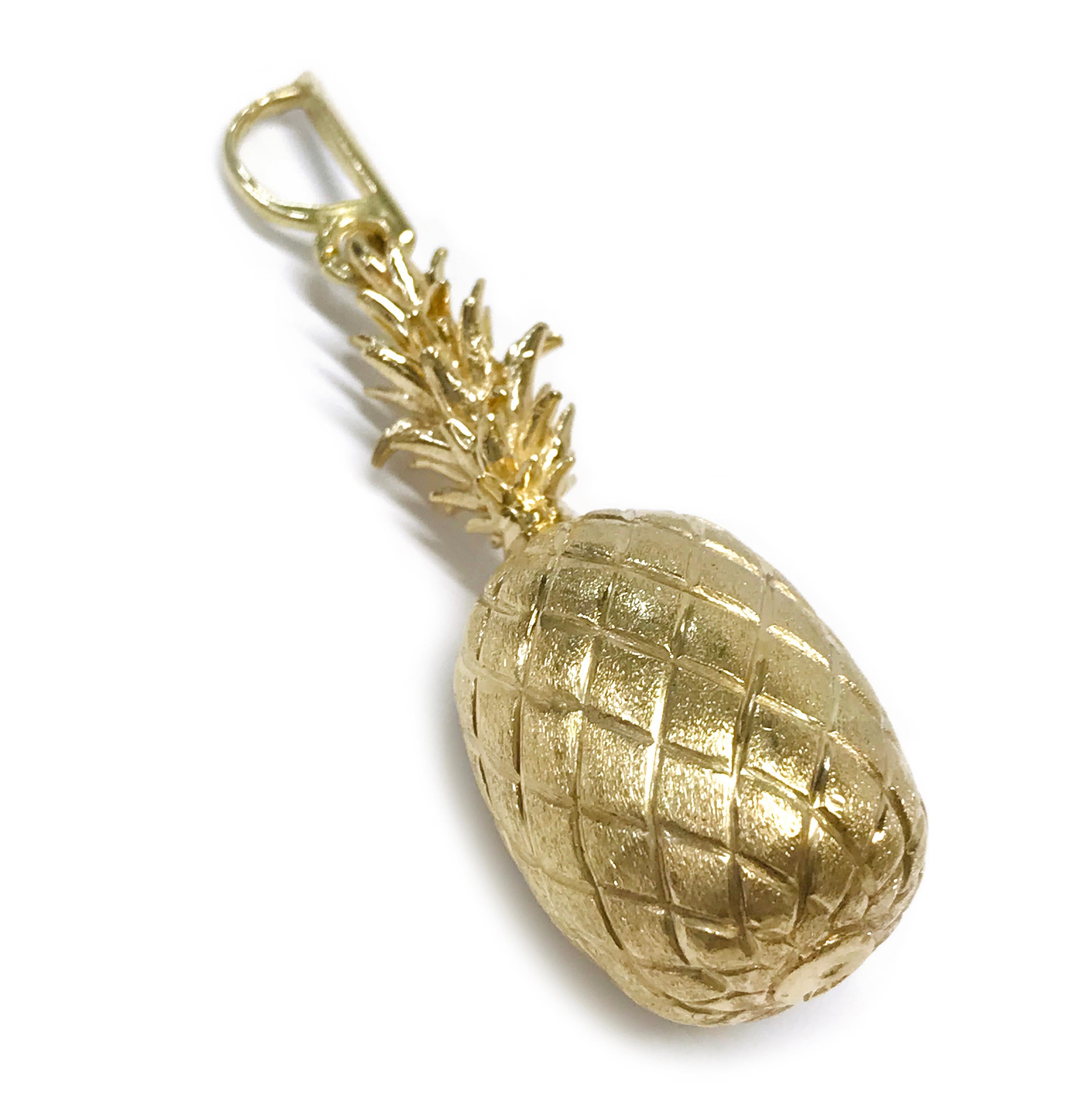 14 Karat Gold Heavyweight Pineapple Pendant. This is an exceptionally well-crafted pendant/charm. The realistic pineapple design has the fruit outlines with a Florentine finish and the crown offers texture and contrast. The pendant measures 0.66mm