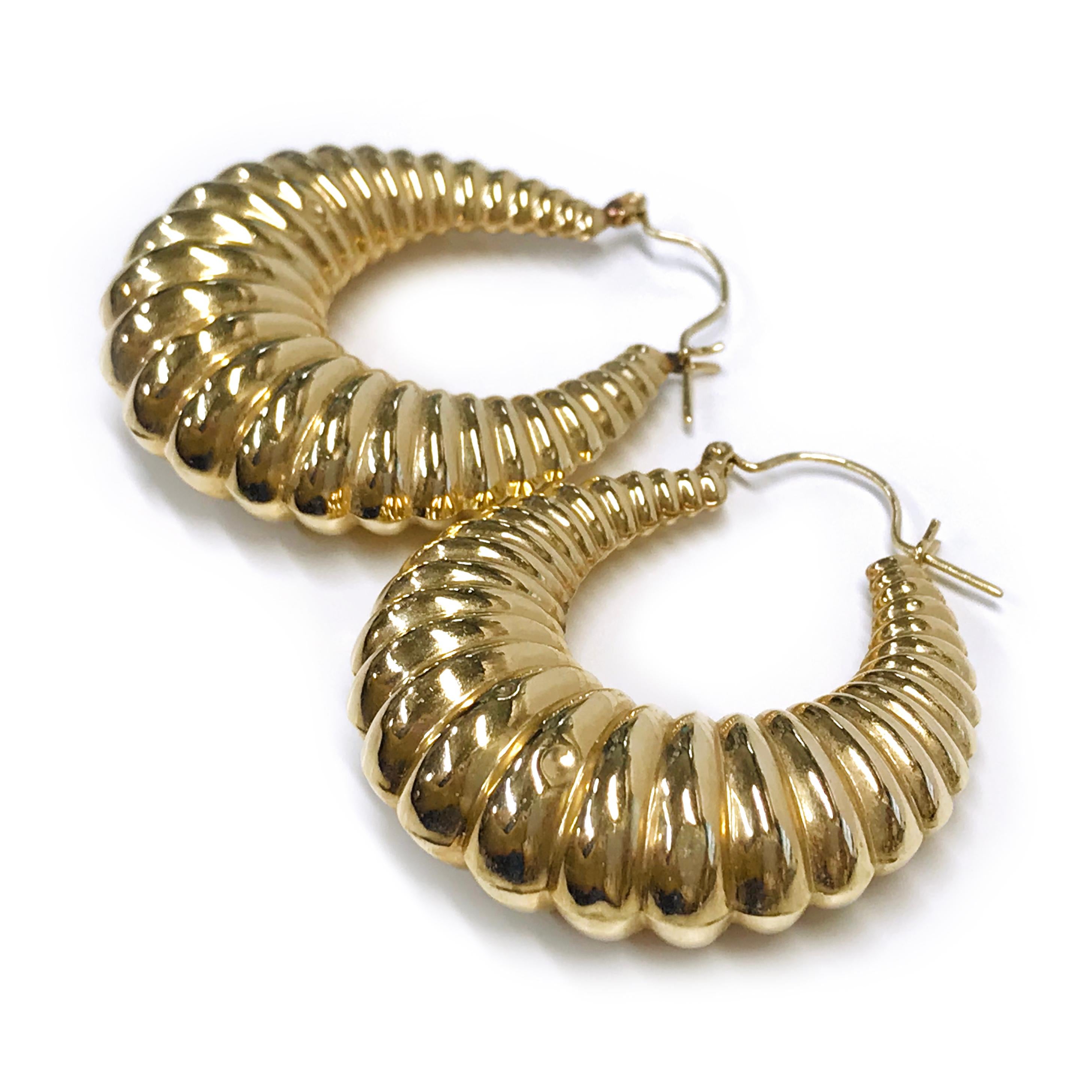 14 Karat Gold Hoop Doorknocker Earrings. These lightweight hollow shrimp hoops are the perfect accessory. Both earrings have small dents at the lower part of the earrings, see photos. The earrings have a hoop wire closure. The total gold weight of