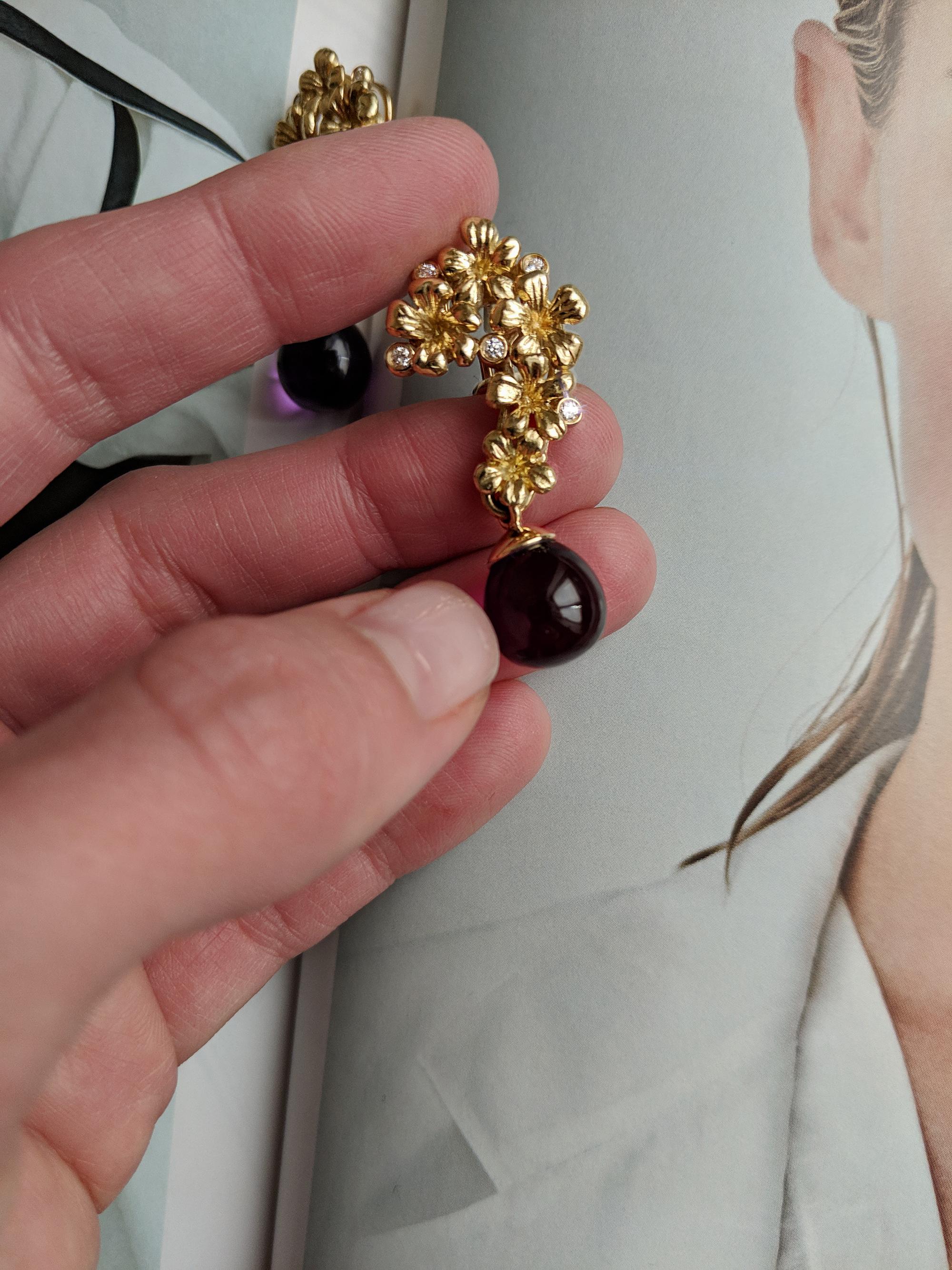 Plum Blossom cocktail clip-on earrings in 18 karat yellow gold are encrusted with 10 round diamonds and cabochon drops of amethysts, which can be taken off and on. Please contact us to choose the better tone of the drops. The earrings were featured