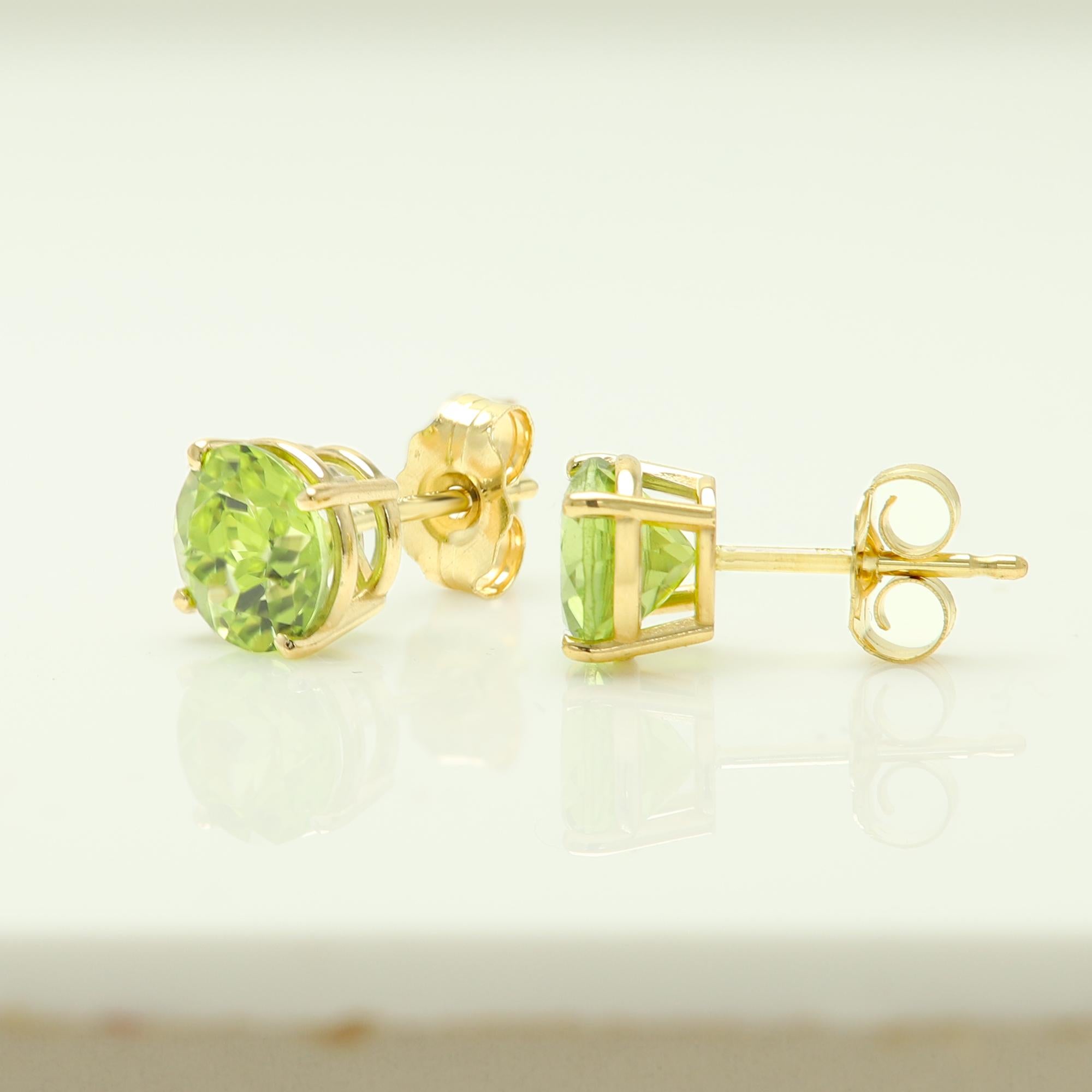 Natural Peridot Gem Earring Studs
Approx. 6.0mm / 0.90 carat - each stone
The Actual color is similar to light green with a pint of yellow. 
Simple but Elegant and real natural gems 
Solid 14k yellow Gold approx weight 1.20 grams
with push back