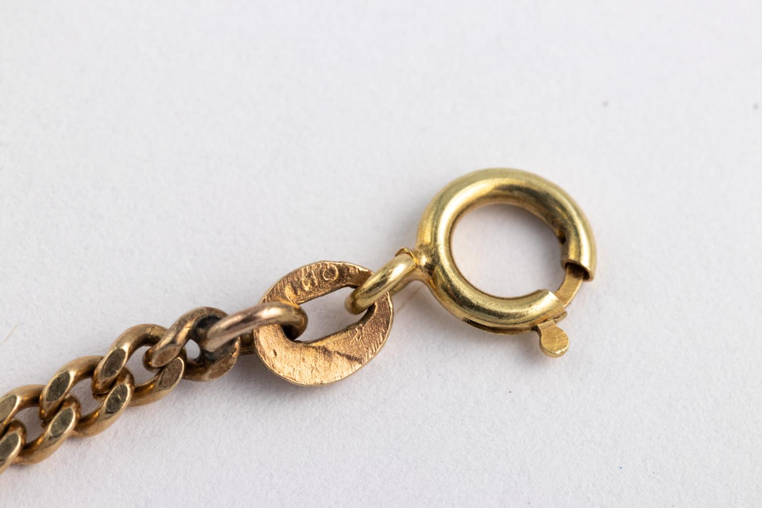 Circa mid 20th century gold necklace consisting of handmade 2.00 inches long abstract heart with linear design in concentric circles. Necklace also features a hinged locket for keepsakes and is soldered to a 14 karat chain to become a pendant