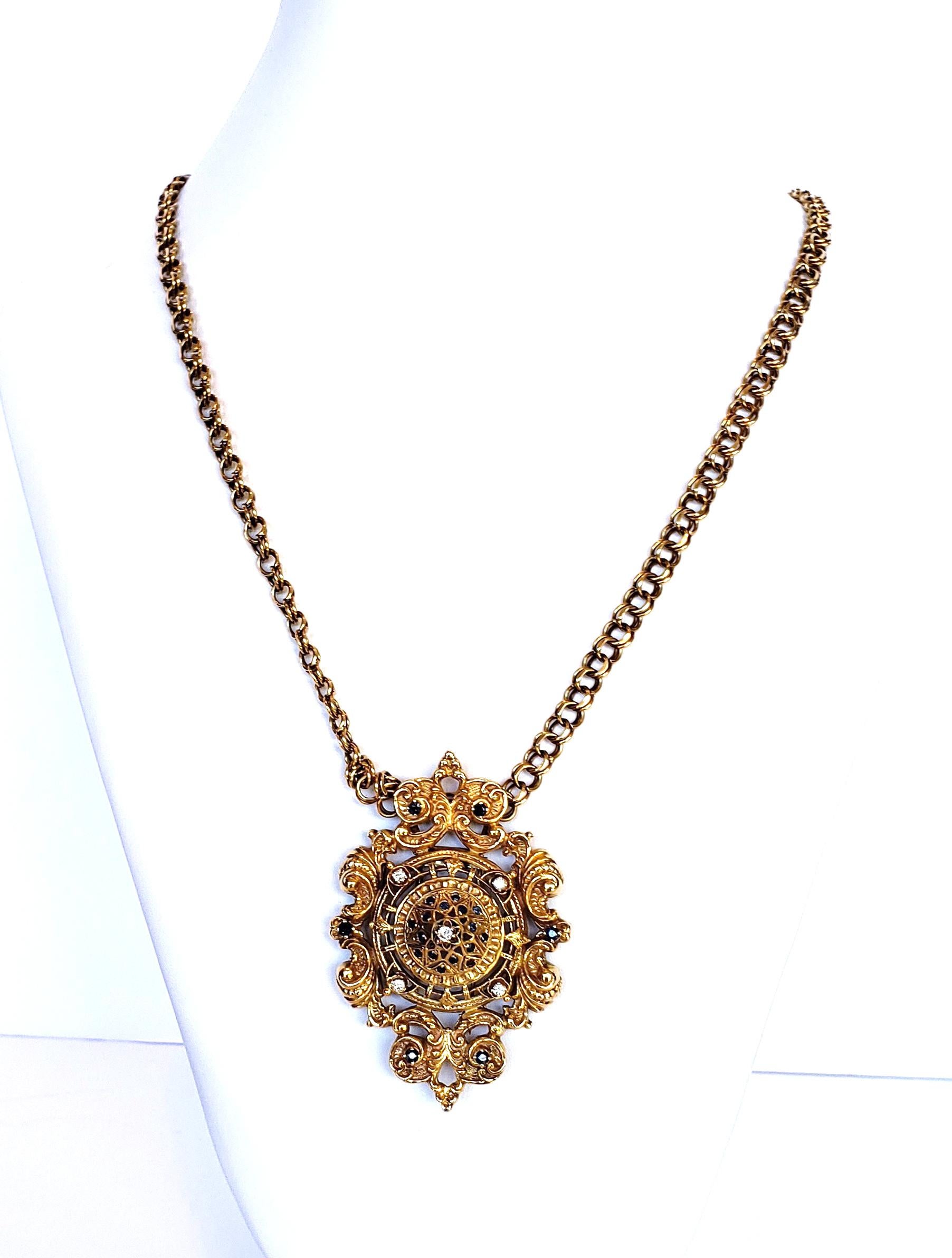 Beautiful 14 karat gold pendant/brooch inset with diamonds and sapphires suspended on a double circular linked chain.
United States Circa 1960

Weight:  80.8 Grams   
Size:  Pendant:  H:  3 1/4”  W:  2 1/4”  Chain: 27”
Total length with pendant:  30