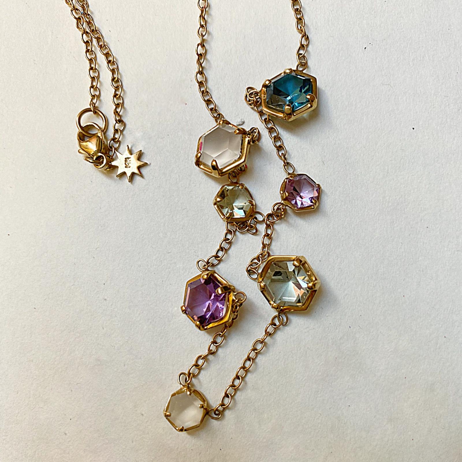 Modern and colorful with custom cut, multi-hued hexagons. Each stone is set along a gold chain, finished with our logo star charm.
Materials: 14 Karat Gold, London Blue Topaz, Green and Lavender Amethyst, Rainbow Moonstone
16/18