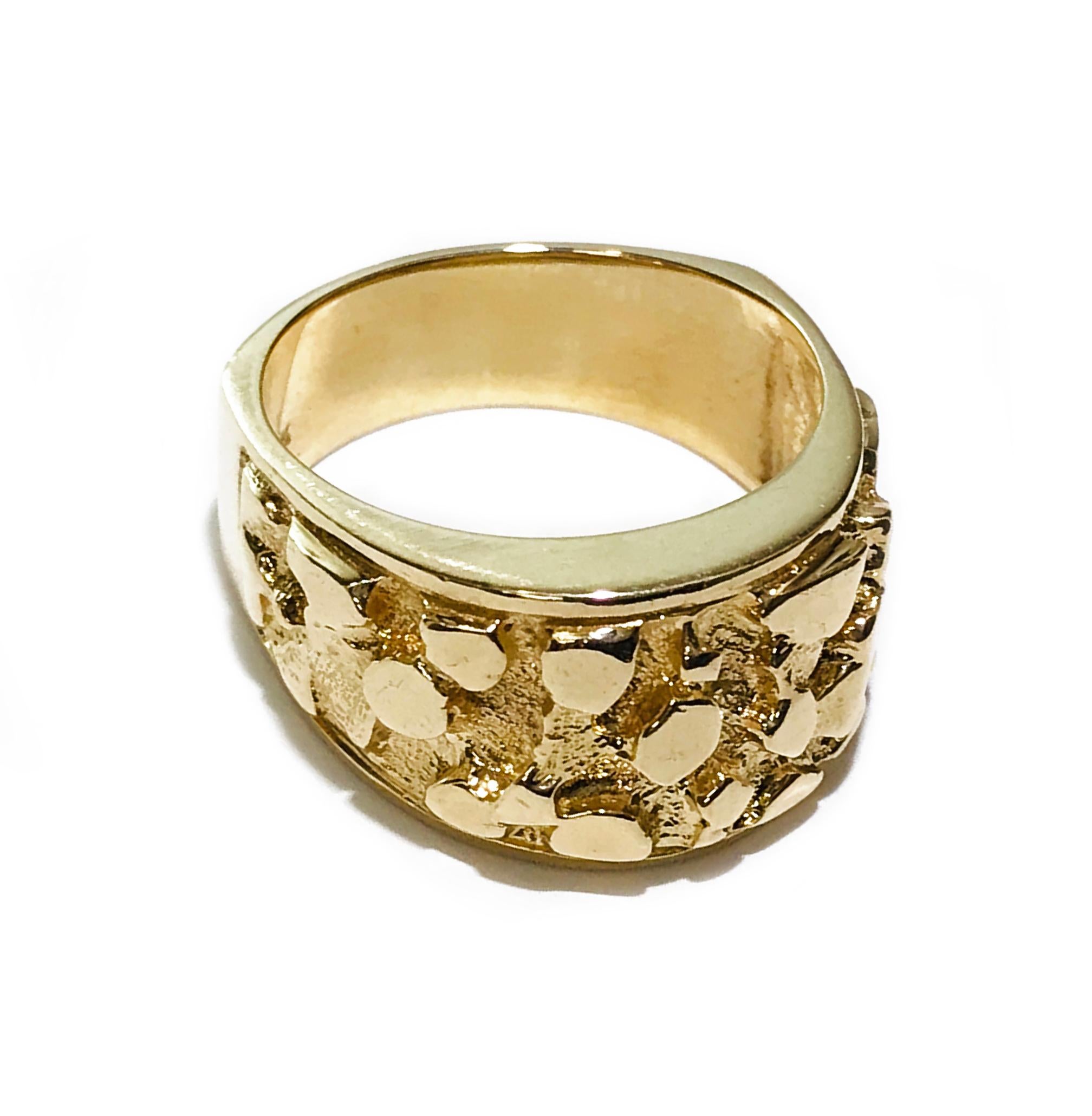 14 Karat Gold Nugget Ring. The retro look is back, approximately half of the ring has nugget texture and the rest is a smooth finish. The wide band tapers and has a Euro shank. Stamped on the inside of the band is 14K. The ring size is 10 3/4.      