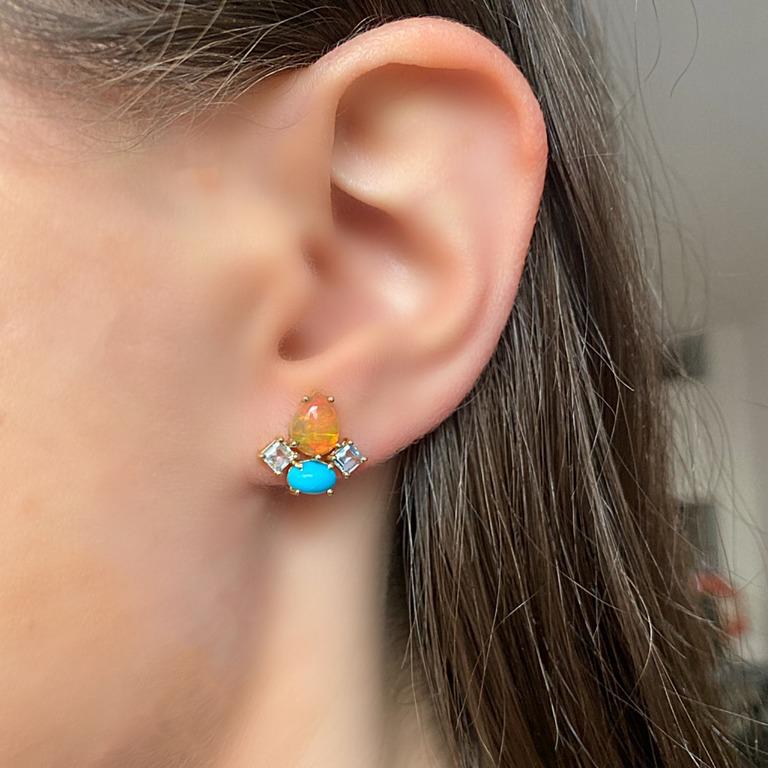 Our Dolce stud earrings feature an interesting mix of shape and color.   Small squares of translucent Aquamarine are set with an Opal pear and a beautiful, rich Turquoise oval.  They are a generous size, so they make a statement which can go from