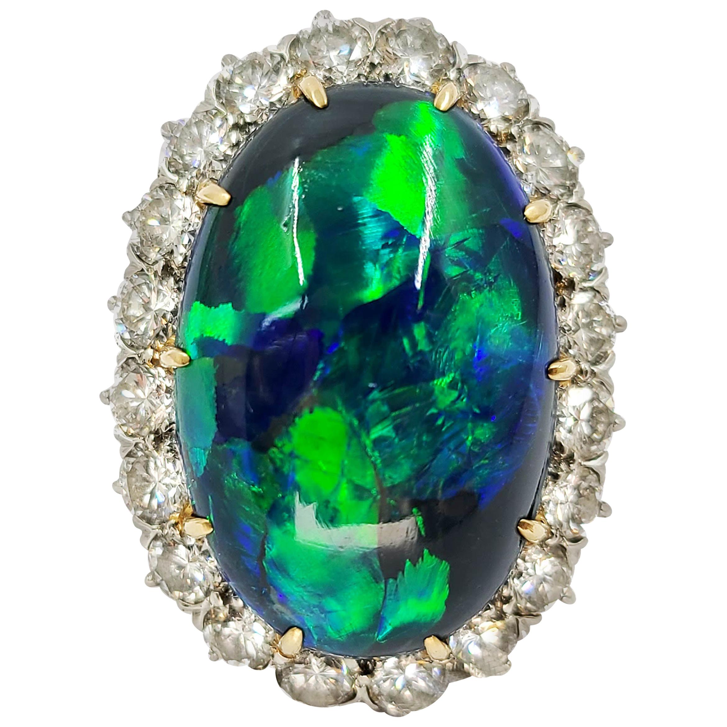 14 Karat Gold Oval Black Opal and Diamond Halo Ring