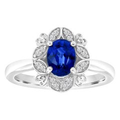 Bague en or 14 carats avec saphir bleu ovale et halo floral en diamants au centre 0,42 carat