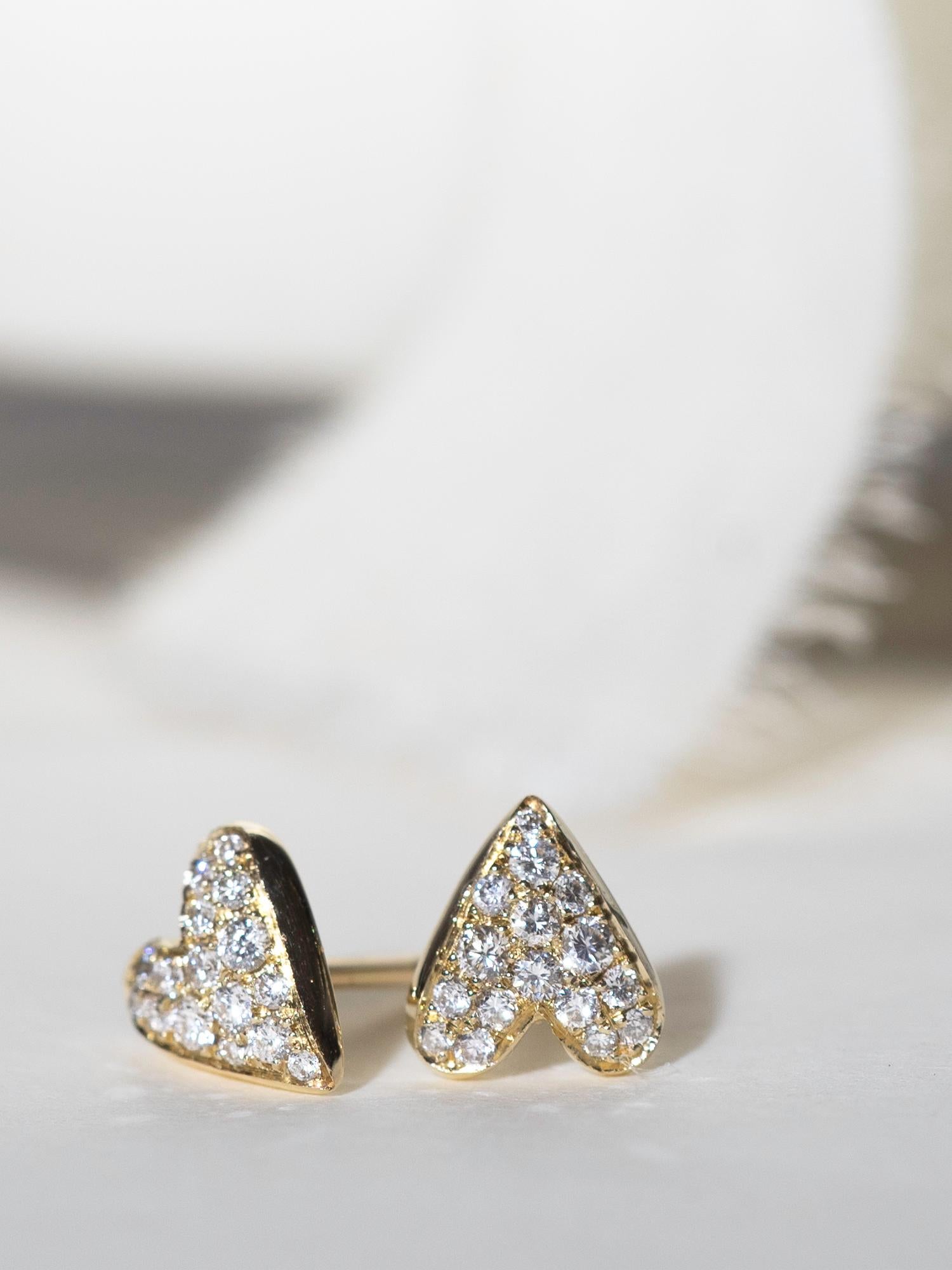 Hand-crafted in 14 karat yellow gold these stud earrings are shimmering perfection. Designed with a slightly domed surface for pavé diamonds to catch and reflect light at all angles, these little symbols of love are the perfect gift for yourself or