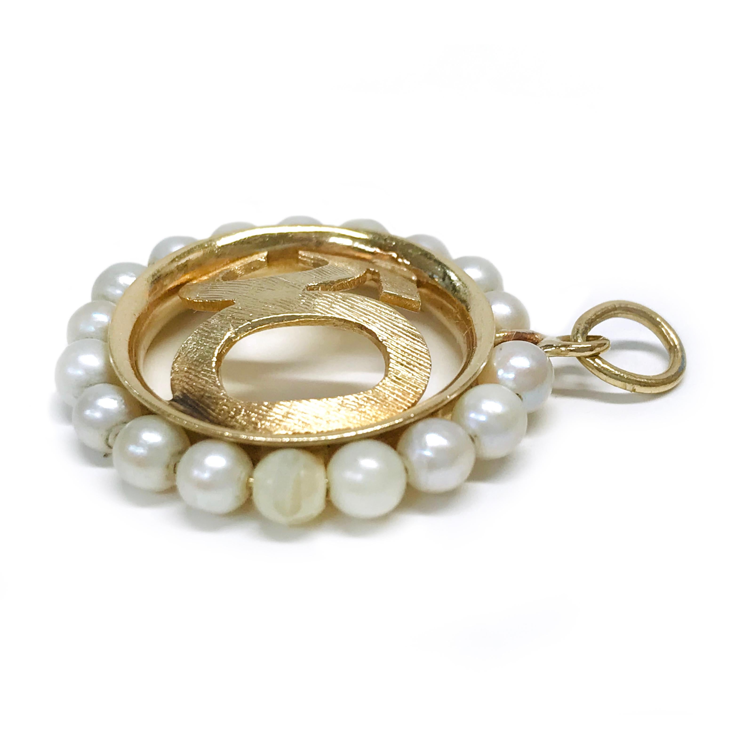 14k Yellow Gold Rembrandt Ring of Pearls Pendant. In the center of the pendant is 50 in gold with an angle satin pattern and eighteen pearls surrounding the center. The pearls are approximately 3.5mm, set on a wire in a circle shape for a simple yet