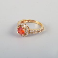 14-karat gold ring adorned with orange opal and numerous brilliant-cut diamonds