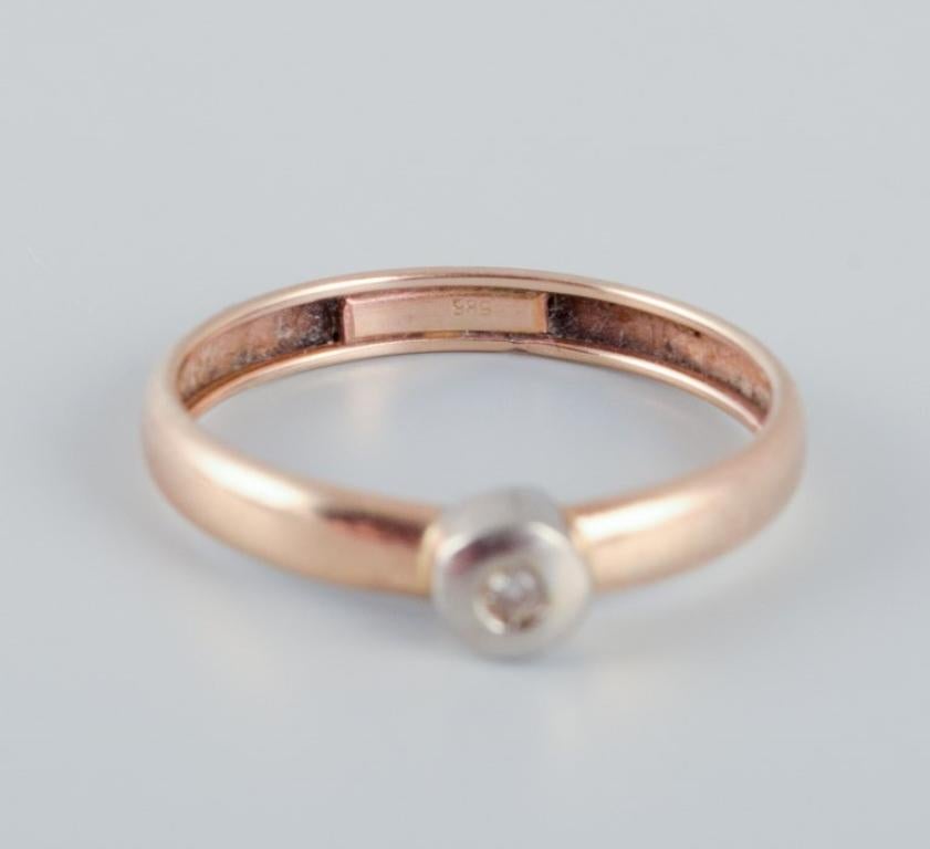 Modern 14-karat gold ring with a small diamond in a modernist design.  For Sale