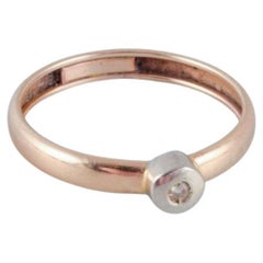 Retro 14-karat gold ring with a small diamond in a modernist design. 