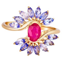 Used 14 karat Gold Ring with Ruby and Tanzanites. Oval ruby ring. Tanzanite ring!