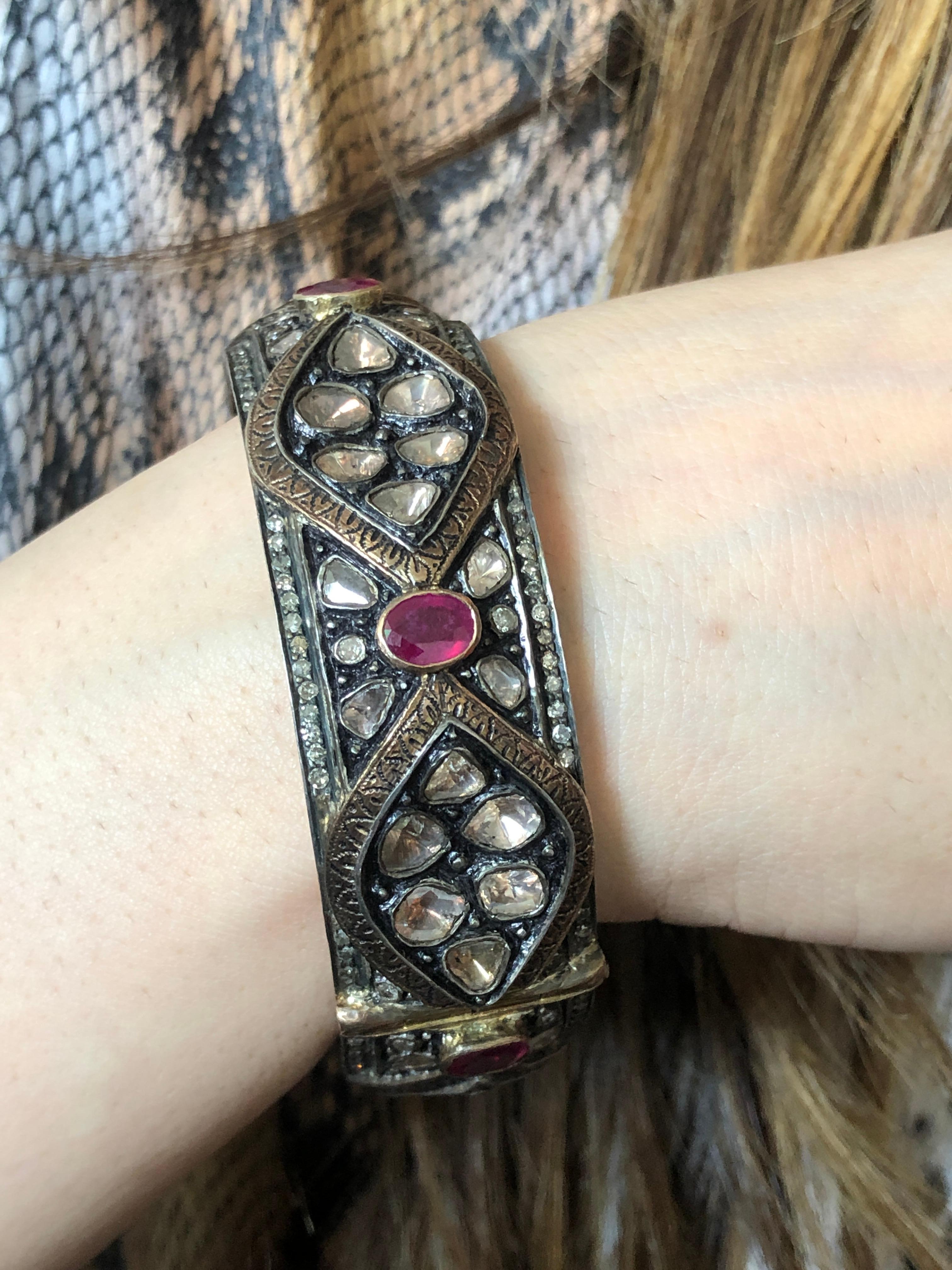 Diamond: 9.50 carats 
Ruby: 5.55 carats
Item Code: DBR BH
Size: 2.25 inches

The perfect addition to any look!
This enchanting 14k Gold bangle studded with Uncut Diamonds and Ruby in sterling silver is as versatile as it looks 


