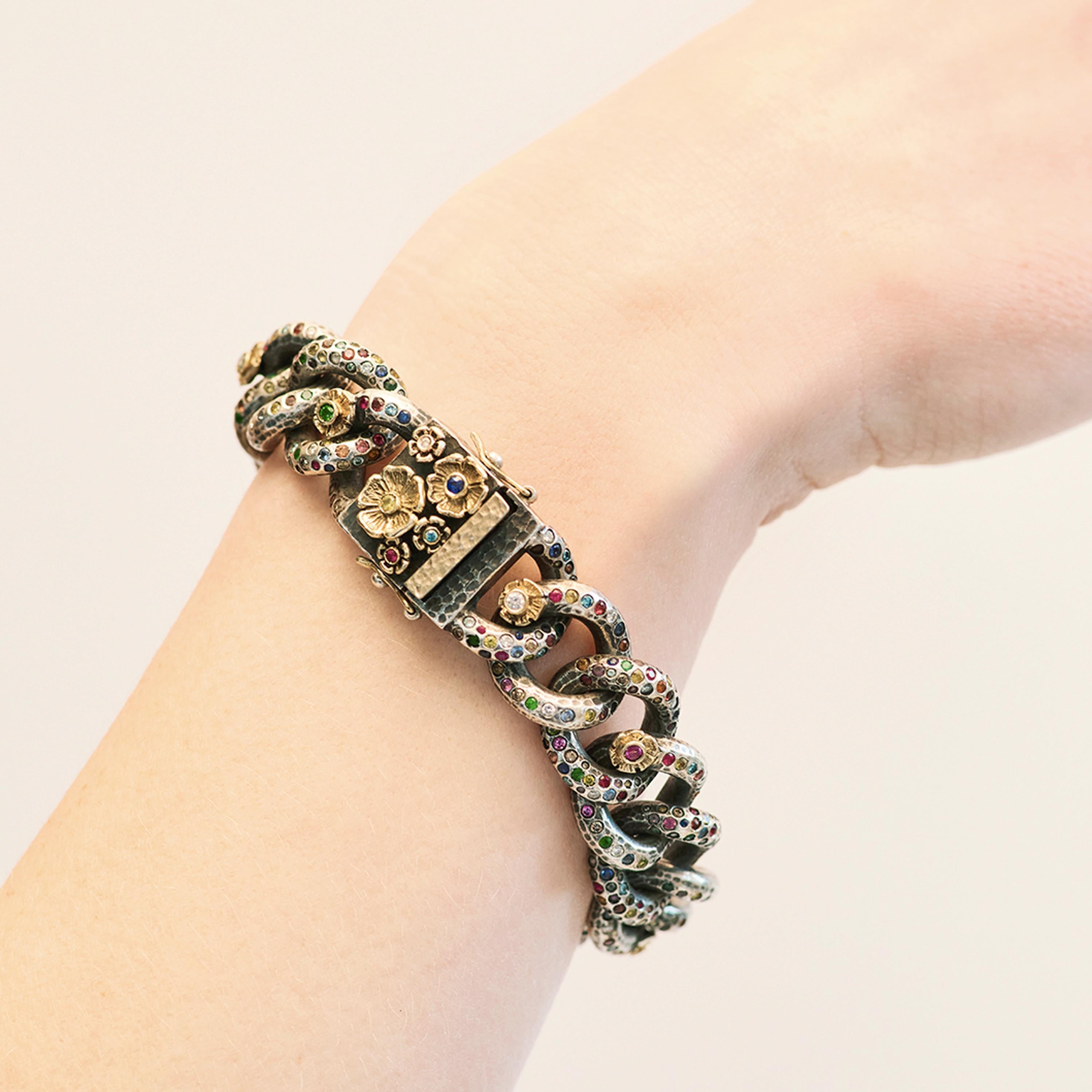 Stella Flame’s Ooak Tutti Frutti Link Bracelet is crafted from 14 karat gold, which has been oxidised. Its dark chain links are scattered with over 600 colour diamonds: white, champagne, blue, yellow and grey diamonds are set amongst pink, yellow,