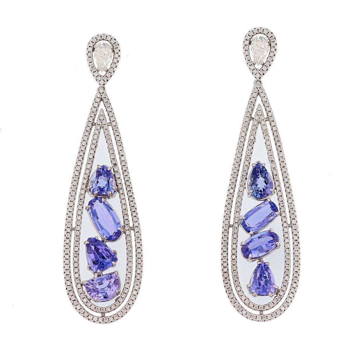 These earrings are made of 14k white gold and features eight tanzanites weighing 8.14ct prong set. The earrings also feature two pear cut diamonds weighing 0.90ct and four hundred round cut diamonds weighing 1.60cts, pavé set. 