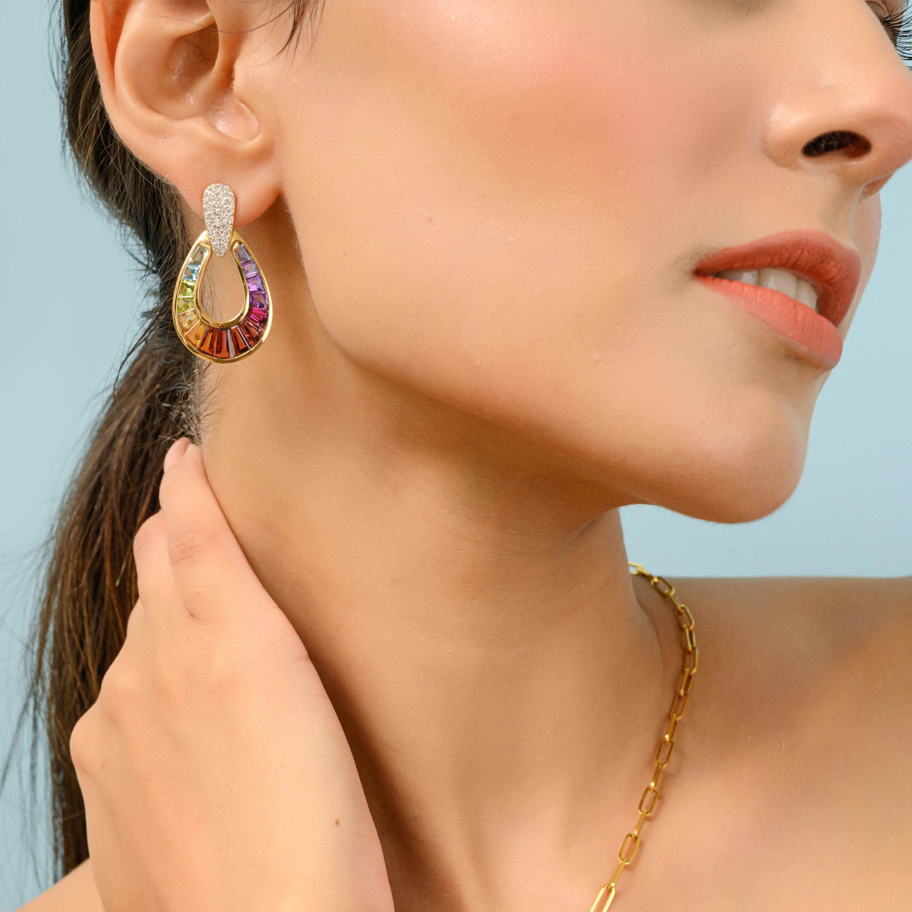 Dazzle and delight with these exquisite 14K gold taper baguette multi-color raindrop-shaped rainbow dangling earrings. These earrings are a true celebration of vibrant hues and exceptional craftsmanship, designed to capture the essence of a