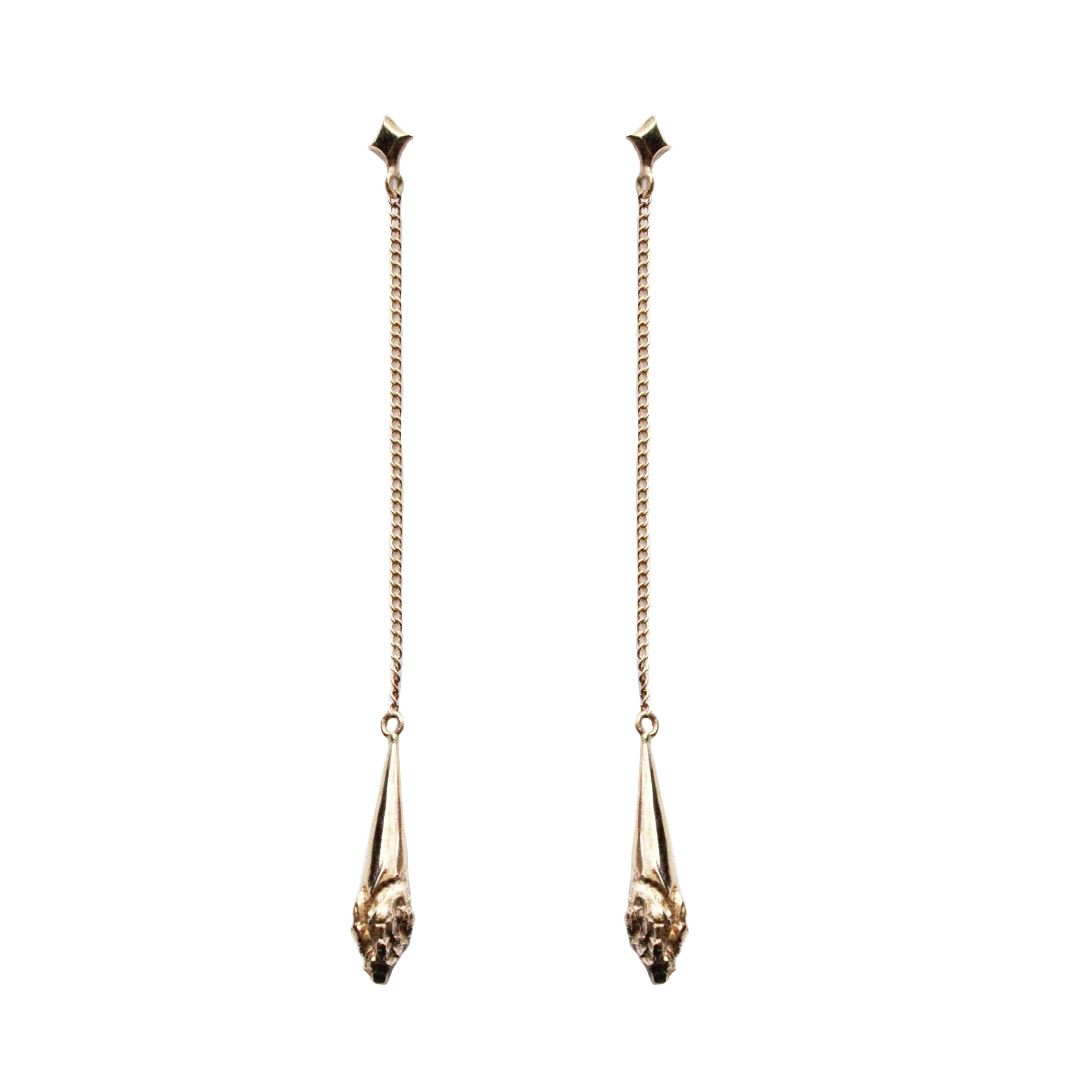 Gorgeous drop earrings cast in 14K gold on a 2.5 inch gold chain that dangles from a kite shape stud. These earrings have a wonderful movement and silhouette that falls mid neck. This pair is unique, highlighting a textured drop of solid gold. The