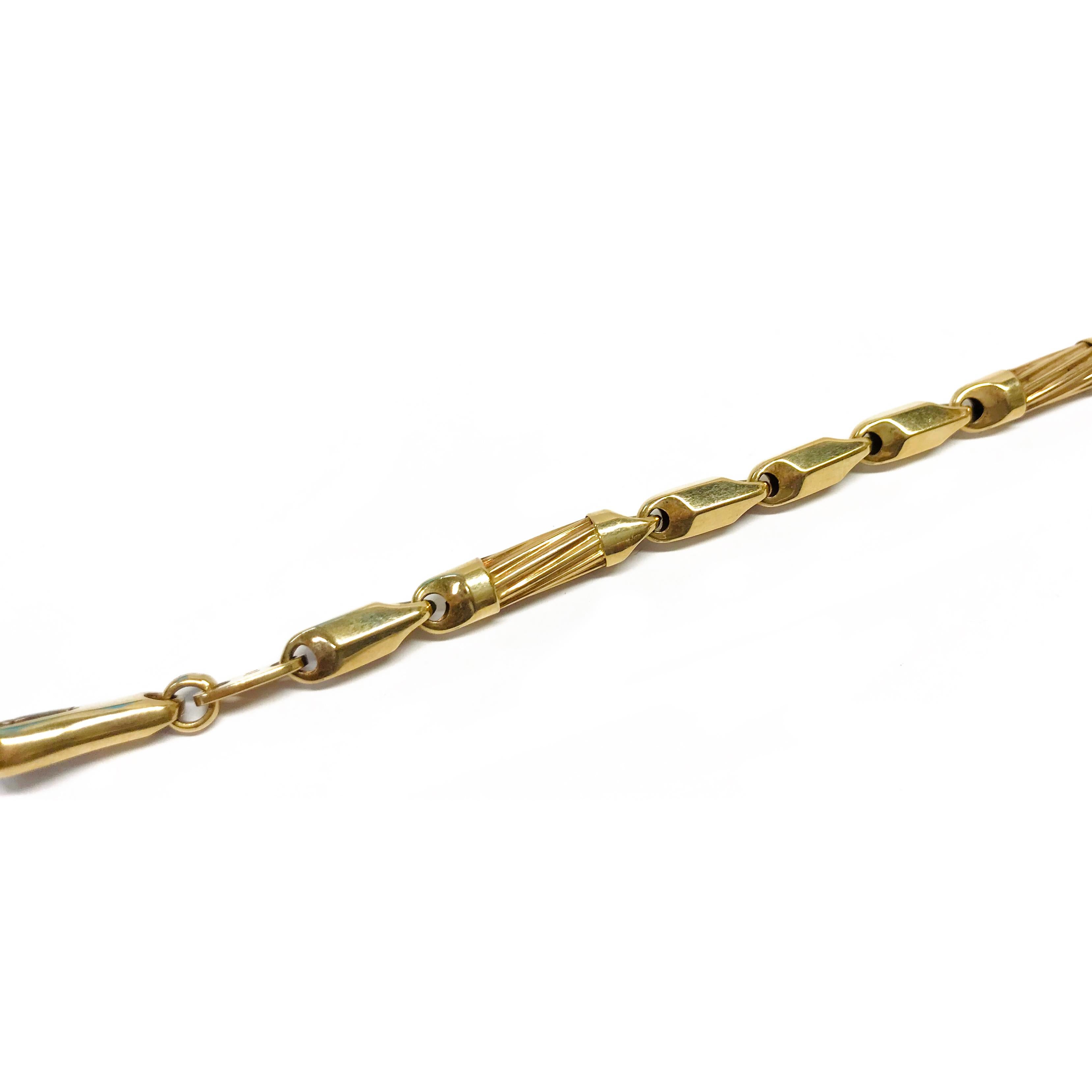 14 Karat Gold Tubular Link Bracelet. The bracelet is 5mm wide, has eleven links, eight are faceted with five sides, and three with angled ridges. Stamped on the inside of the clasp is 14K ITALY. The bracelet is 7.5