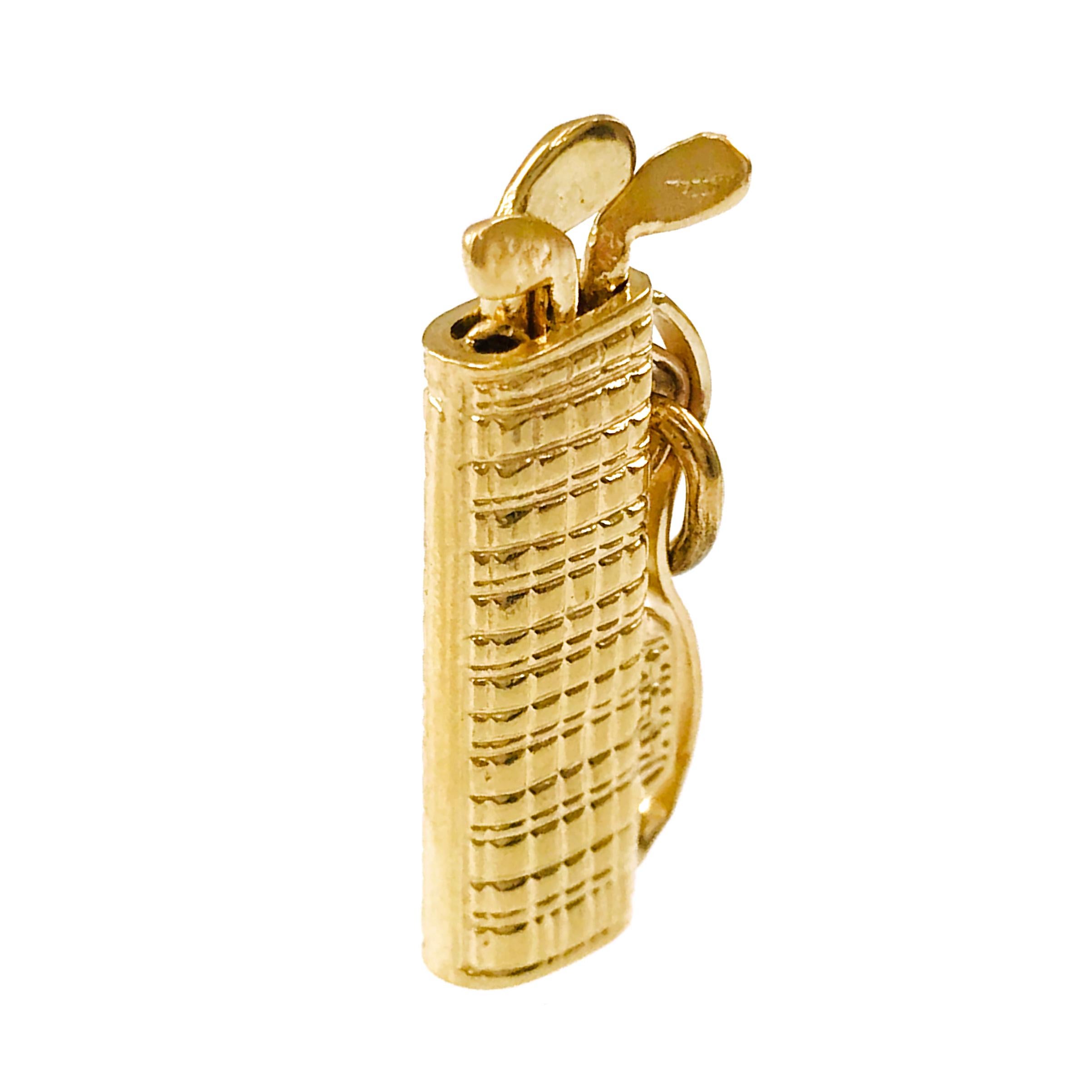 14 Karat Gold Golf Bag Pendant. The pendant features a highly-textured golf bag, side strap, and three golf clubs. The pendant measures 10.6wide x 24.71 tall x 4.21mm long. Stamped on the strap is E14. The total gold weight of the pendant is 2.7