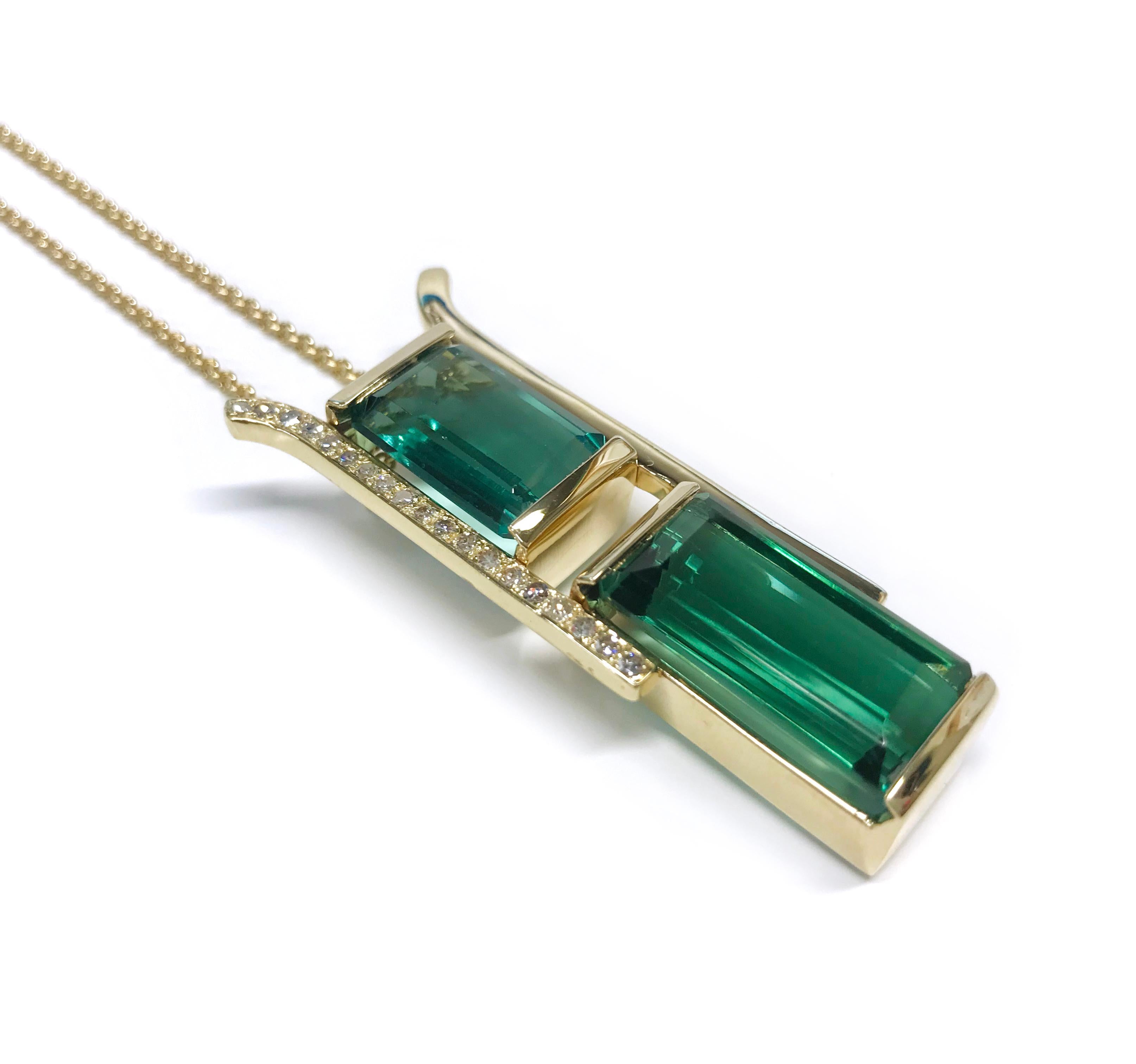 14 Karat Green Tourmaline Diamond Pendant Necklace. Two step-cut green Tourmalines are bezel-set in this large vertical pendant with two side gold bars. One Tourmaline measures 16.2mm x 11.2mm x 7.1mm for a total carat weight of 10.25ct and the