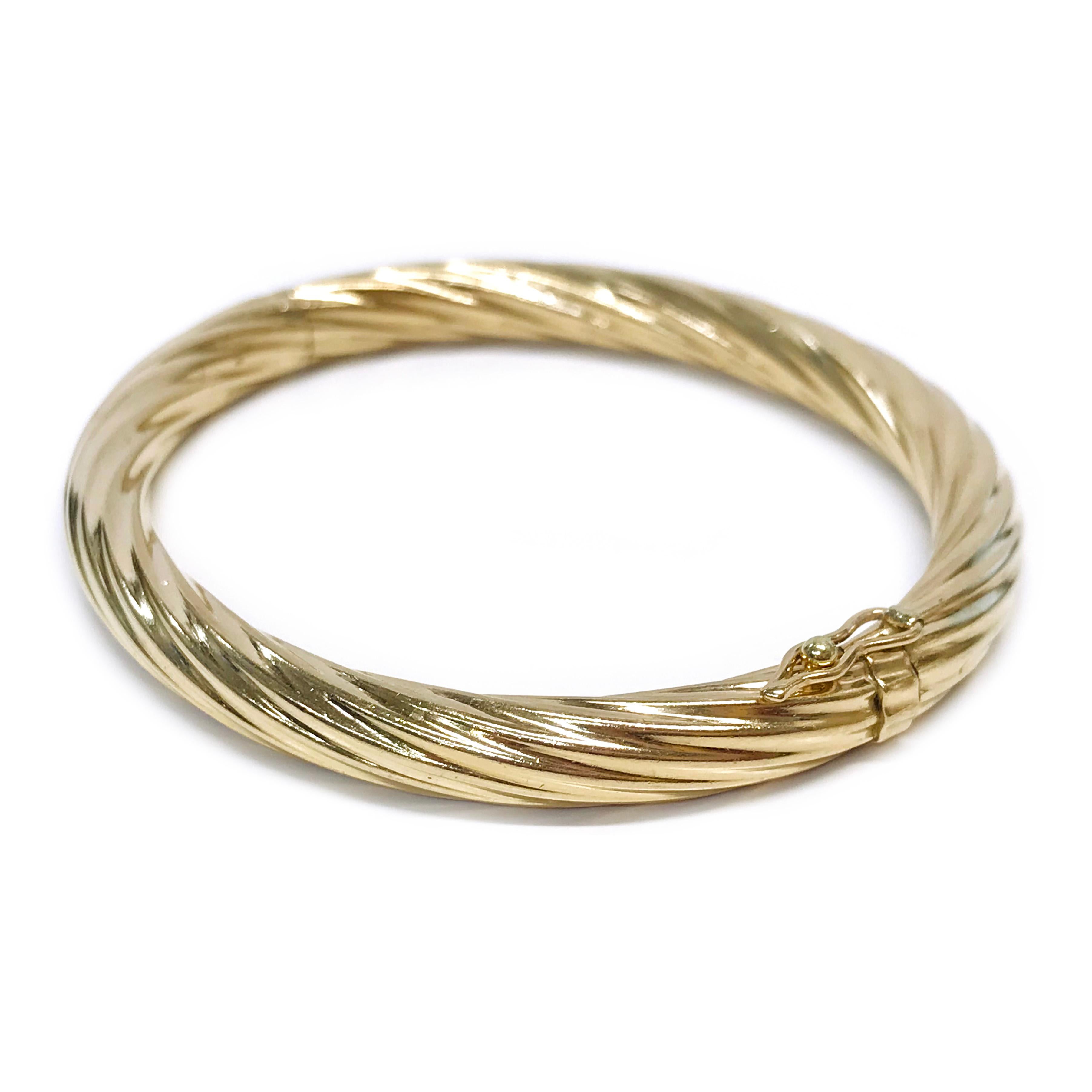 14 Karat Yellow Gold Hinged Cable Bangle Bracelet. The classic cable bangle is semi-oval with a width of 6.2mm. Stamped on the clasp is the maker's mark B. The total gold weight of the bangle bracelet is 16.7 grams.