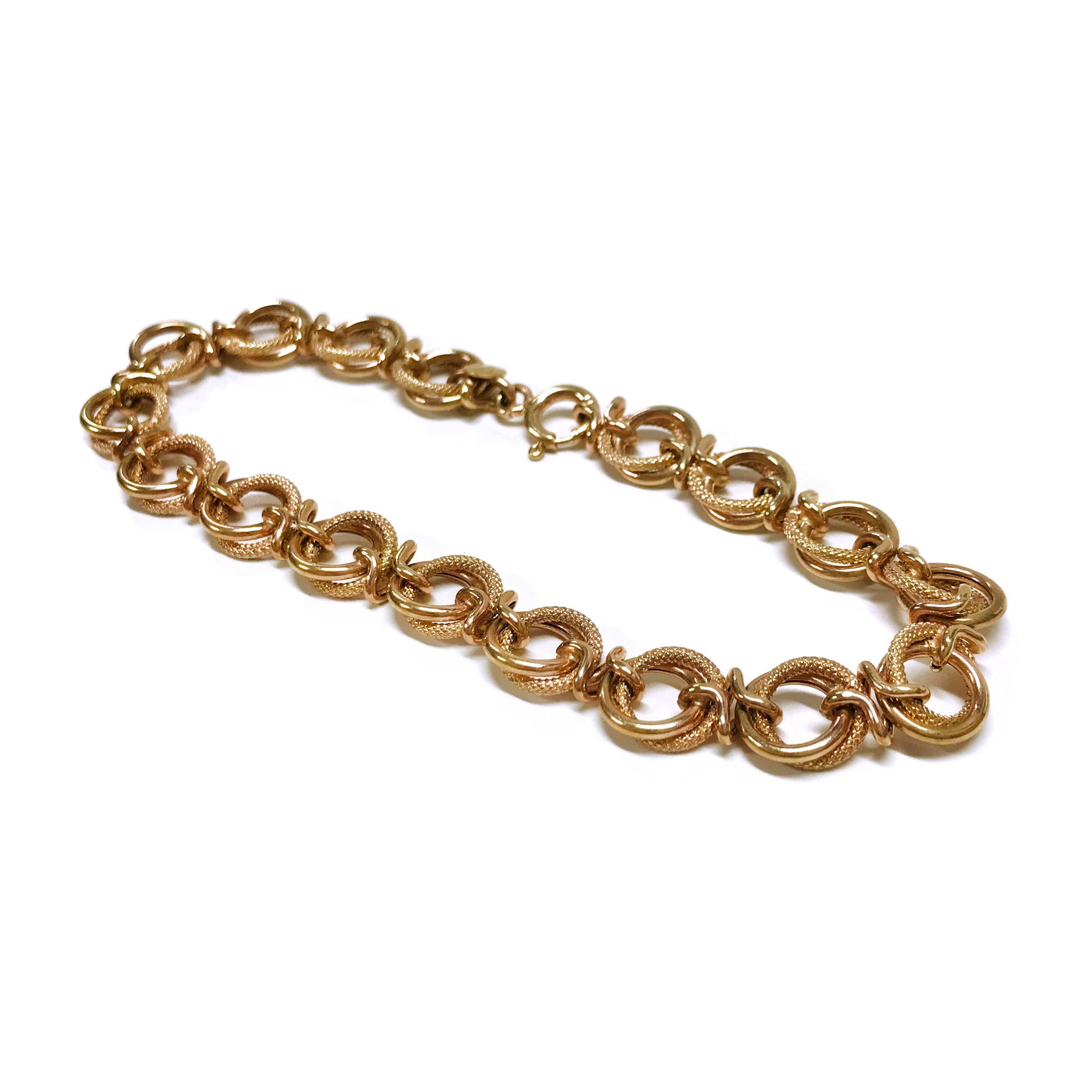 14 Karat Italian Rose Gold Double Link Bracelet. This bracelet features double links, one textured and one smooth linked together by unique twisted links. The bracelet is 8mm wide, 7.5