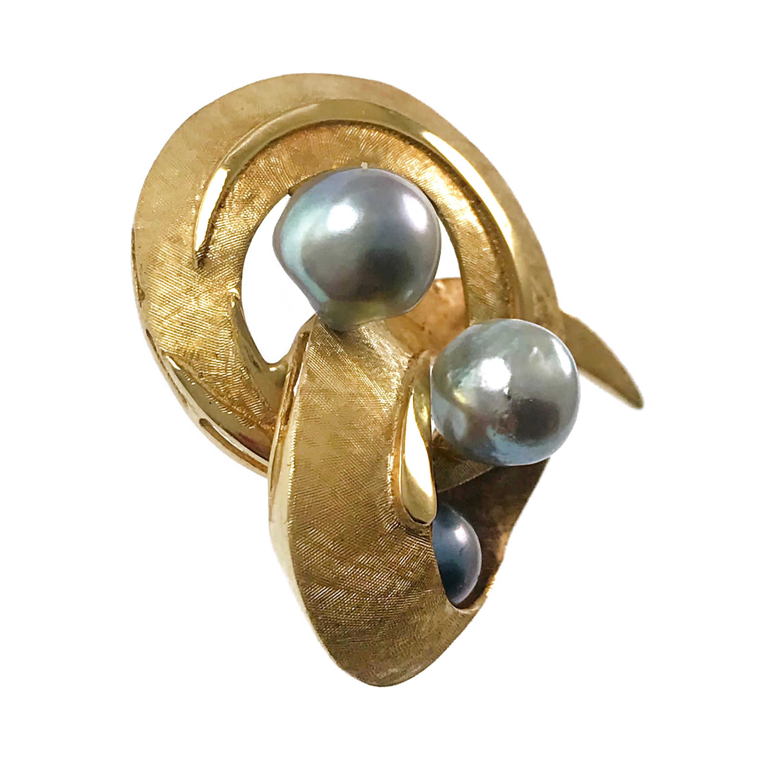 14 Karat J.R. Co Pearl Swirl Brooch. This brooch features three Baroque blue-gray (drilled) Pearls in varying sizes set in a dynamic swirl. The gold swirl is textured in a Florentine finish with a smooth finish in the center. The Pearls are A
