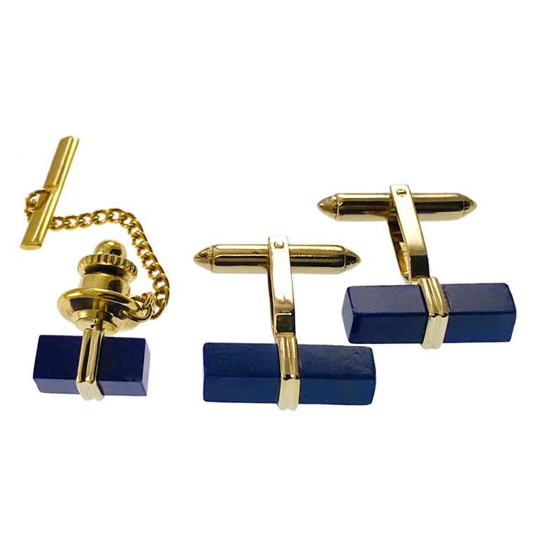 14 Karat Lapis Lazuli Set - Cufflinks and Tie-Tack. The cufflinks consist of a rectangular block of Lapis Lazuli with a gold center, a dual post, and torpedo toggle backings. The cufflink measures approximately 19.6mm x 5.1mm and the total weight of