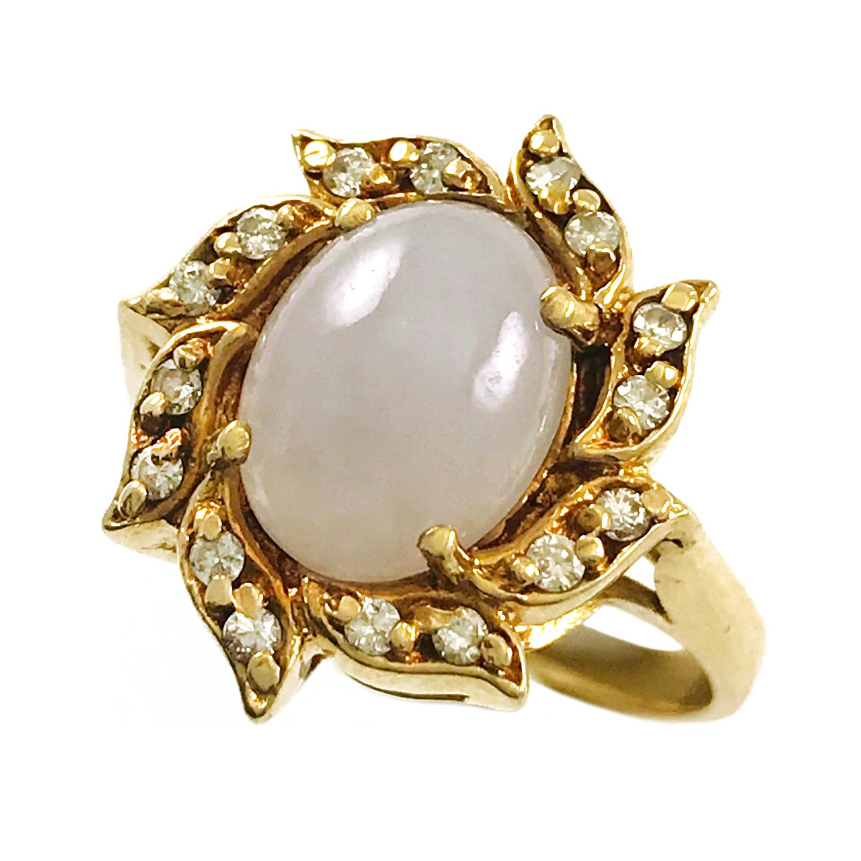 14 Karat Lavender Jade Diamond Ring. This floral design features a prong-set 8mm x 10mm oval Jade cabochon with gold leaves around the center stone and two diamonds on each leaf for a total of sixteen diamonds. The diamonds measure 1.72mm for a