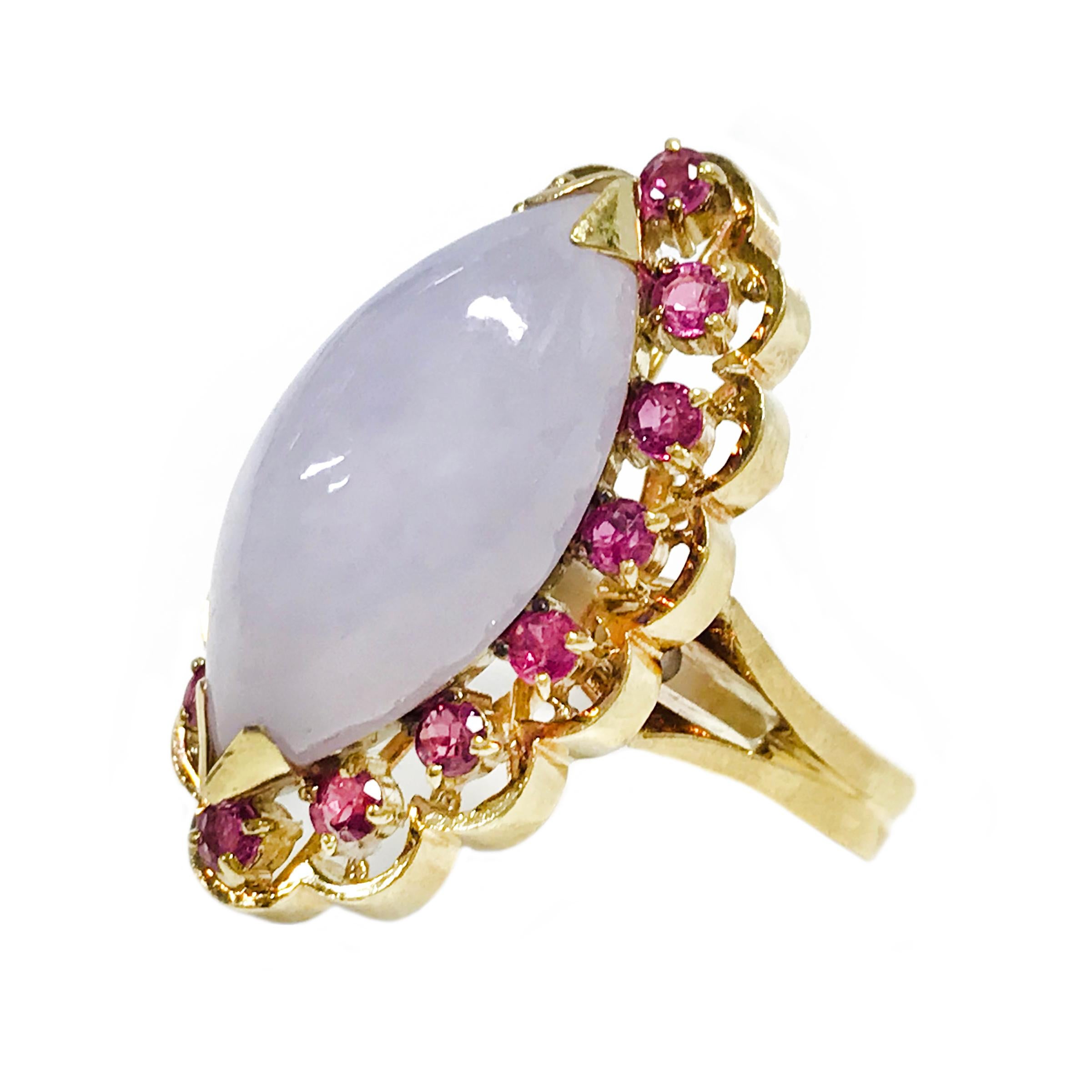 14 Karat Lavender Jade Ruby Navette Cocktail Ring. The ring features a lavender jade marquise cabochon measuring 21.1 x 9.72mm with fourteen round Rubies all prong-set measuring 2.35mm each. The ring size is 7 3/4. The total gold weight is 11.55