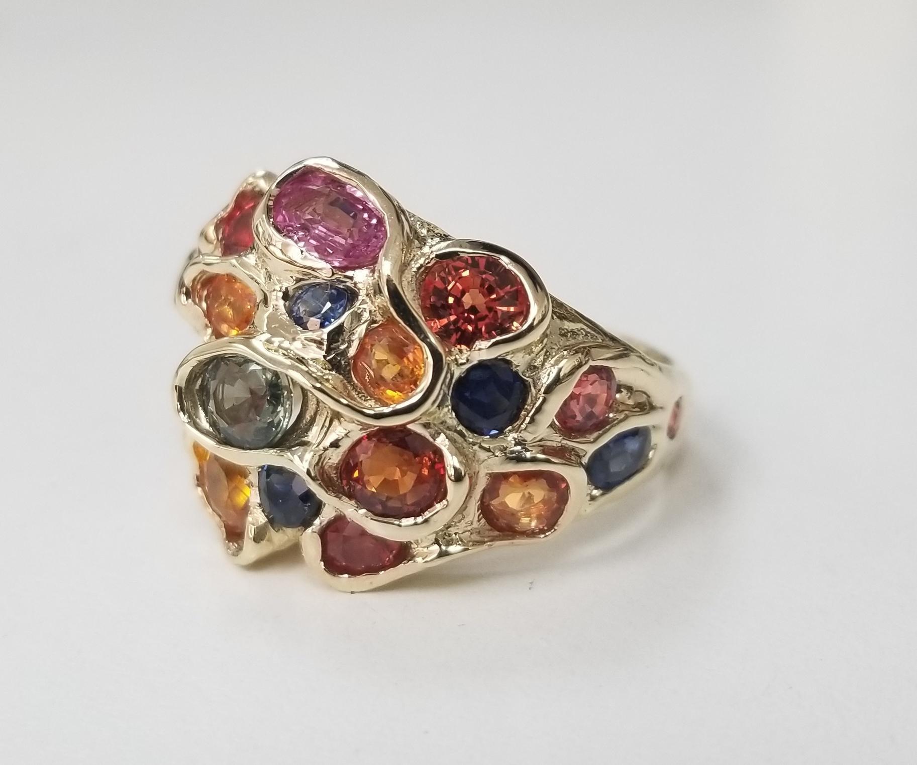 14 karat multicolored sapphire cluster ring, containing 25 round sapphires (orange, yellow, blue, green and lavender) of very fine gem quality weighing 6.43cts.  This ring is a size 7 but we will size to fit for free.