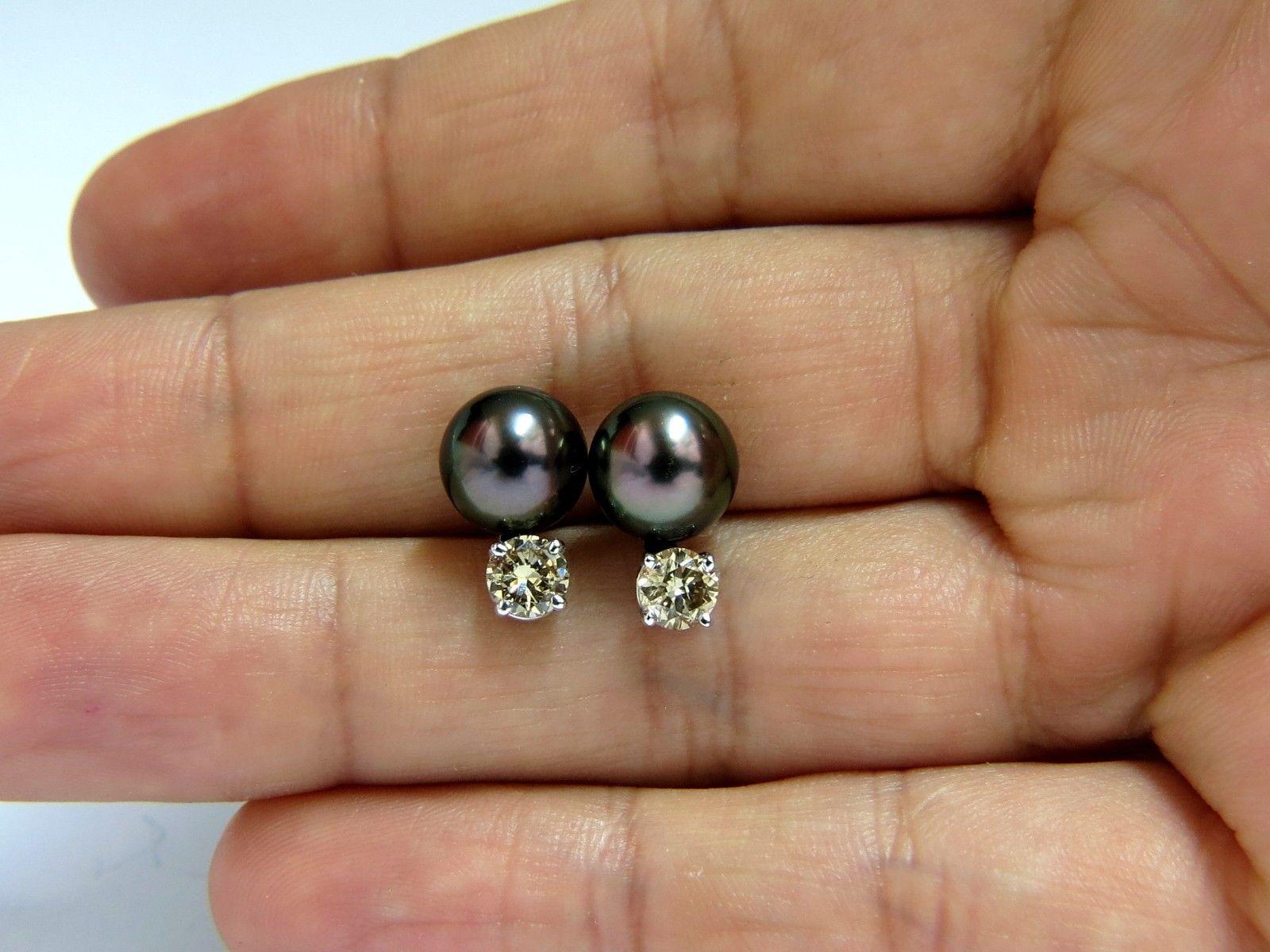9mm Natural Tahitian Black Peacock pearls Studs

Pearls are natural, Black lipped oyster.

No pits, nicks or dents of any sort.

AAA Excellent Luster

Diamonds: 1.00ct. 

Natural fancy yellow brown color.

Rounds, full cut brilliants.

14kt. white