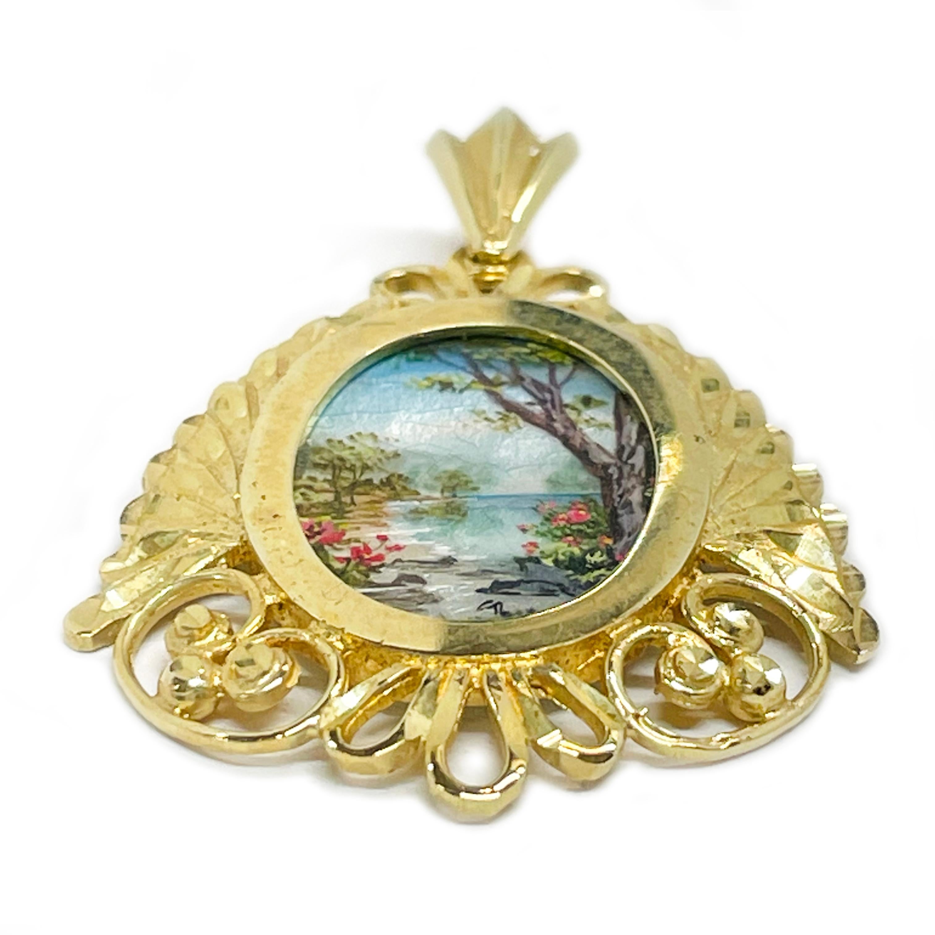 14 Karat Yellow Gold Hand Painted Ocean Scene on Mother of Pearl Pendant. Absolutely lovely ocean scene with tree in the foreground painting. The miniature painting is set in a 14 karat gold ornate oval frame with diamond-cut details. The painting