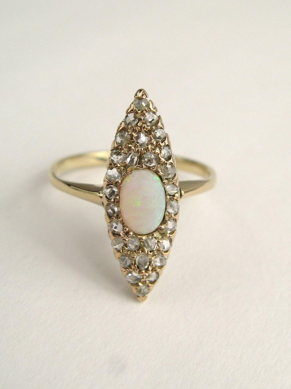 This wonderful antique Victorian opal and Rose Cut Diamond Ring is set in 14K gold. The ring measure .78