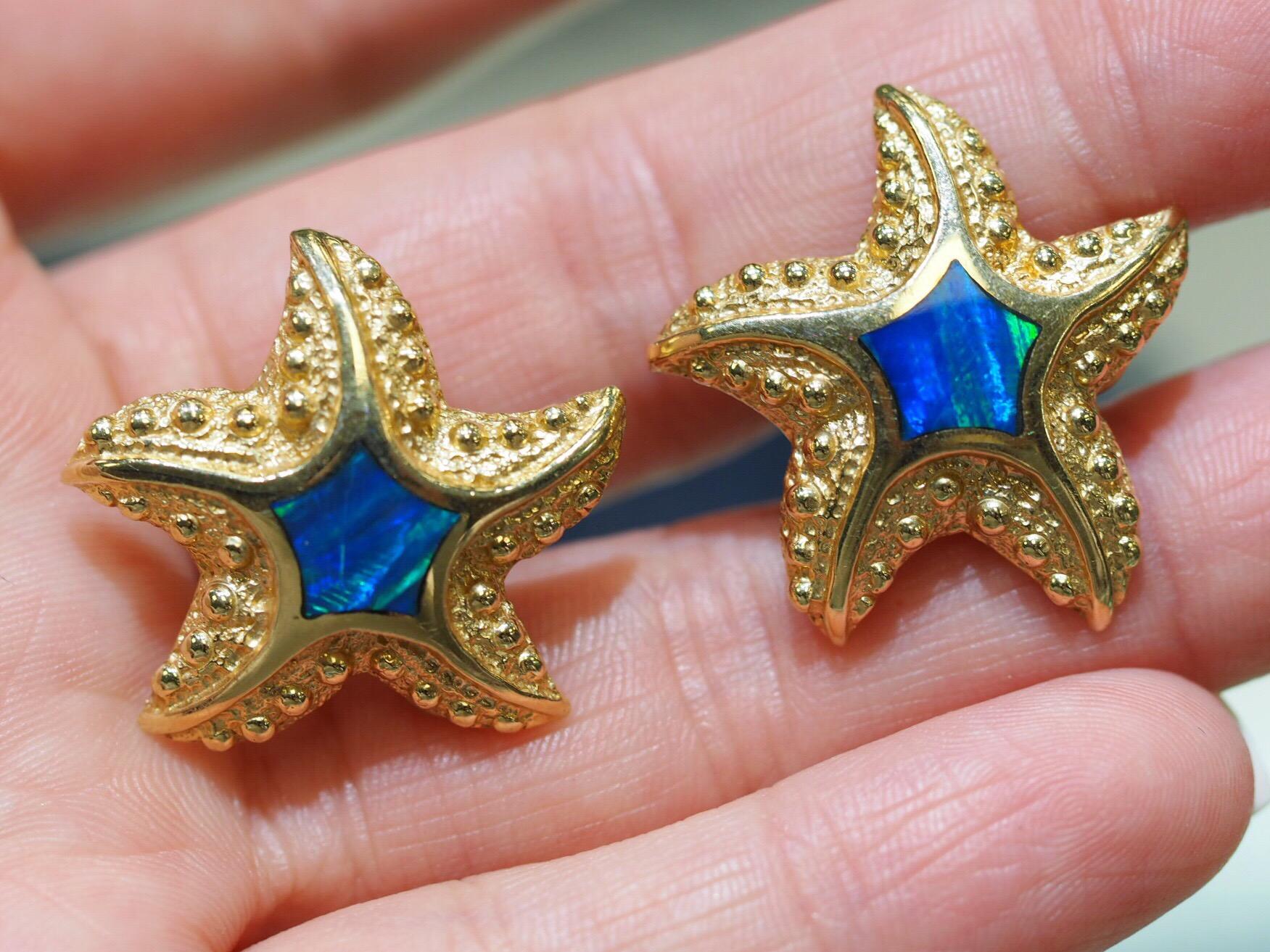 Beautiful 14k Yellow Gold Starfish earrings with blue-green Opal in the center. The earring backs have a post with clip. weighing 9.1 grams.