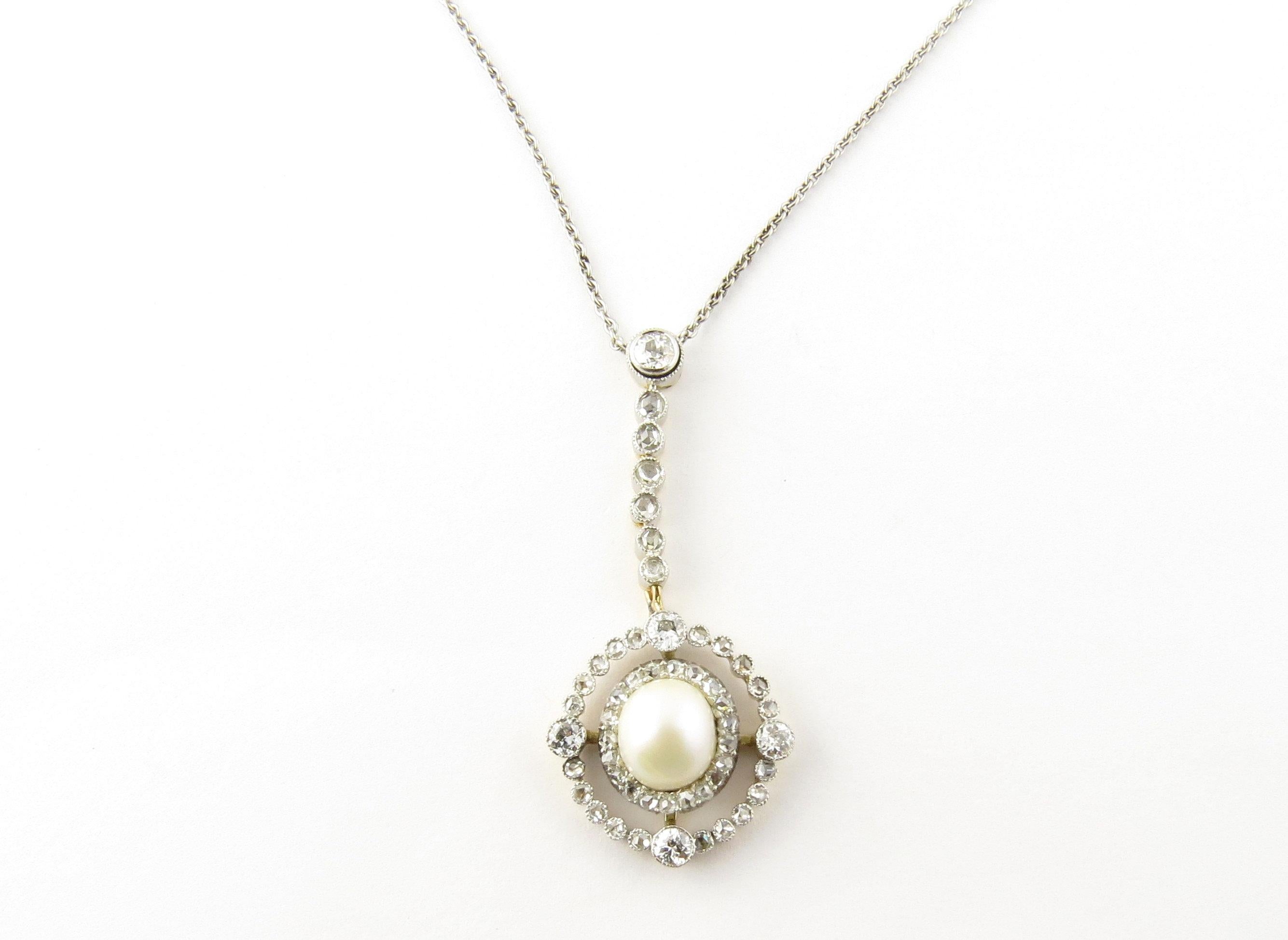 Vintage 14 Karat White Gold Pearl and Diamond Pendant Necklace. This stunning pendant features one 7 mm cultured pearl accented with 51 round European cut diamonds set in classic 14K white gold. Suspended from a 14K white gold necklace. Circa