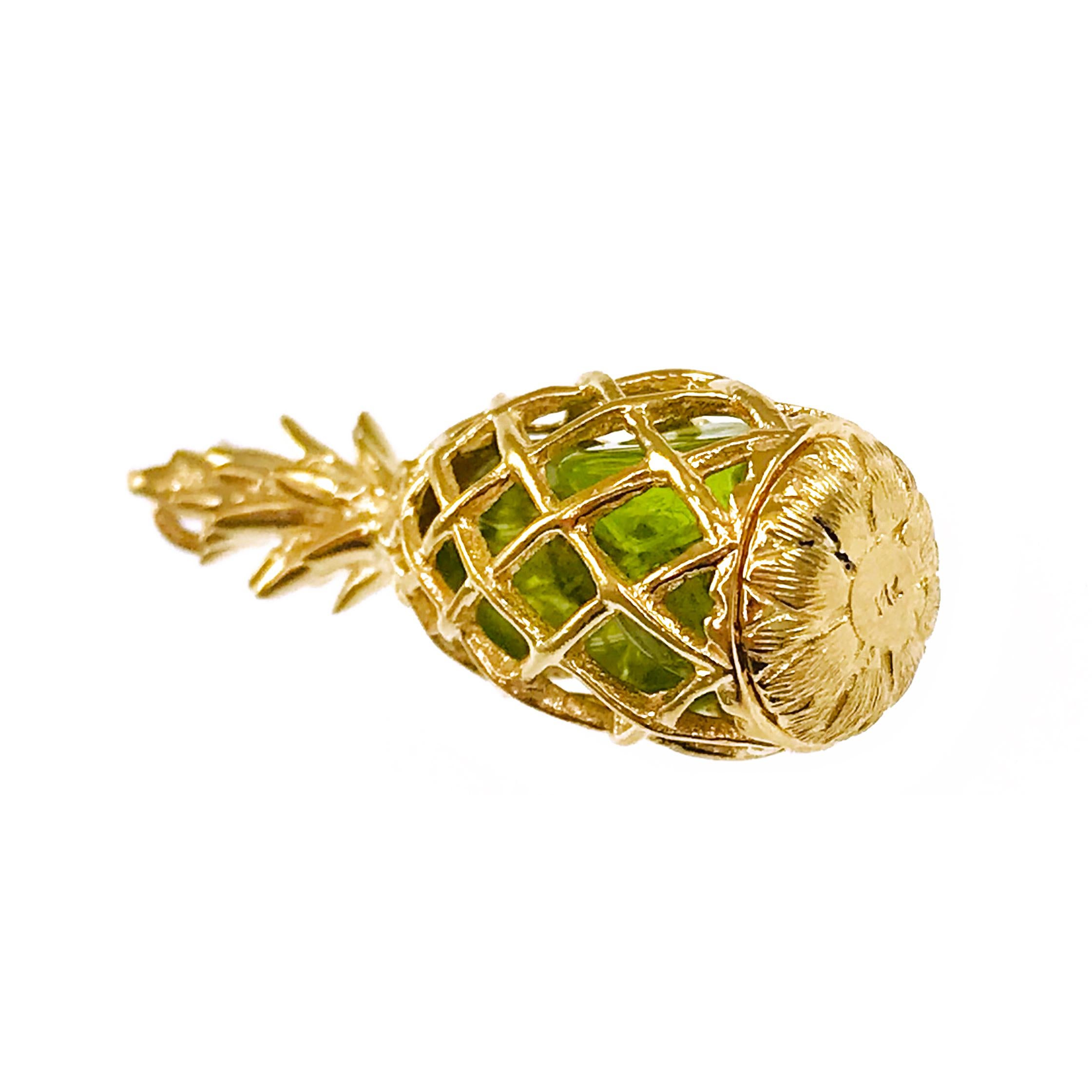 14 Karat Peridot Pineapple Pendant. This exceptionally well-crafted pendant/charm features four peridot stones inside. The pendant measures 12 wide x 32.7mm tall. Stamped on the bottom of the pendant is 14K. The total gold weight of the pendant is