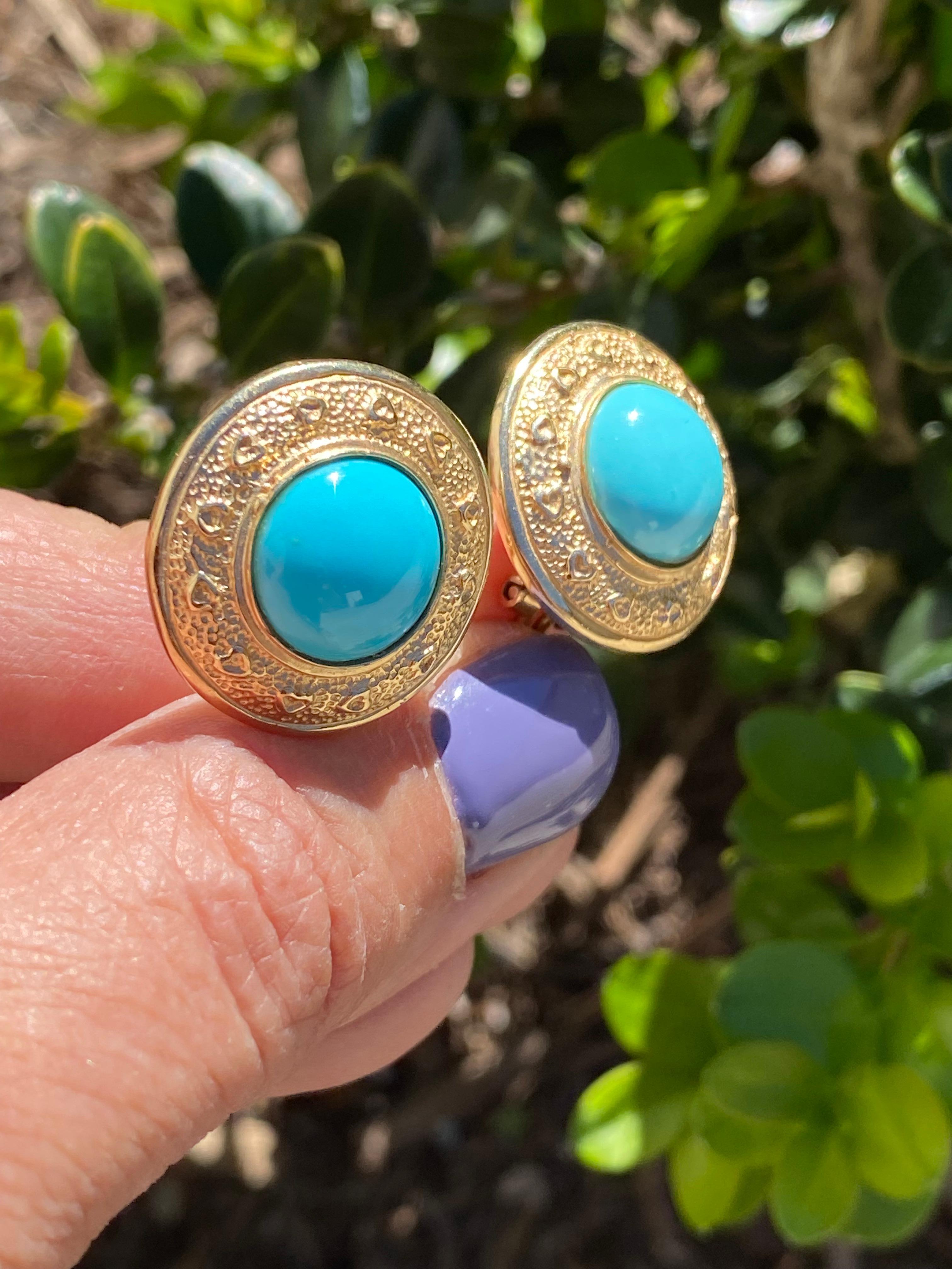 14 Karat Persian Turquoise Cabochon Earrings, 22 mm 
The bezel of the earrings is designed with small hearts on a textured border.
Turquoise is 12 mm and pure colored.
Earrings can be adjusted to a clip style by removing the post.
10.7 grams of 14