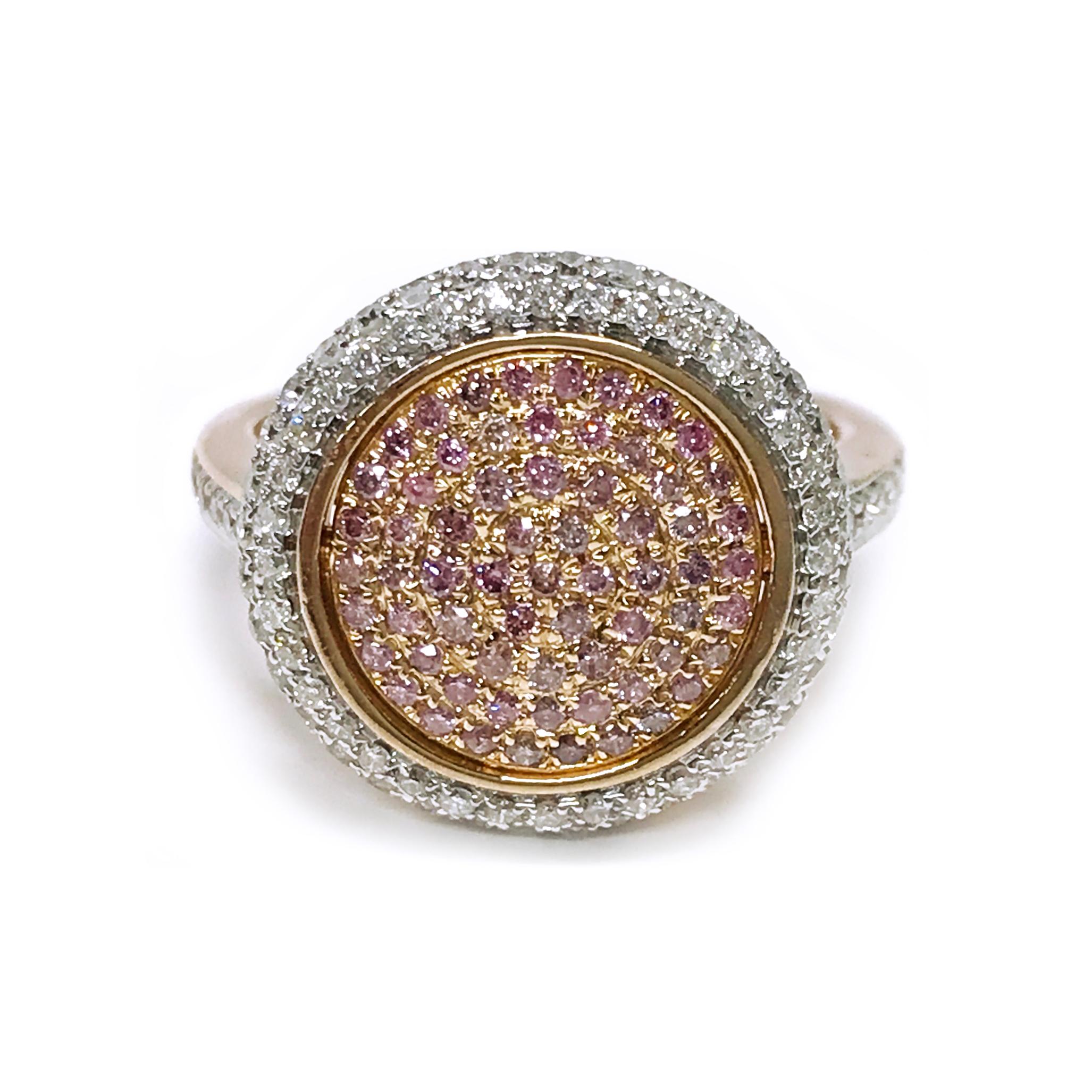 14 Karat Rose Gold Natural Pink Diamond Pavé Ring. This beautiful ring features pink diamonds pave-set in the center of the ring in a dome and a double halo of bead-set white diamonds. There are six side diamonds on each side of the band and the