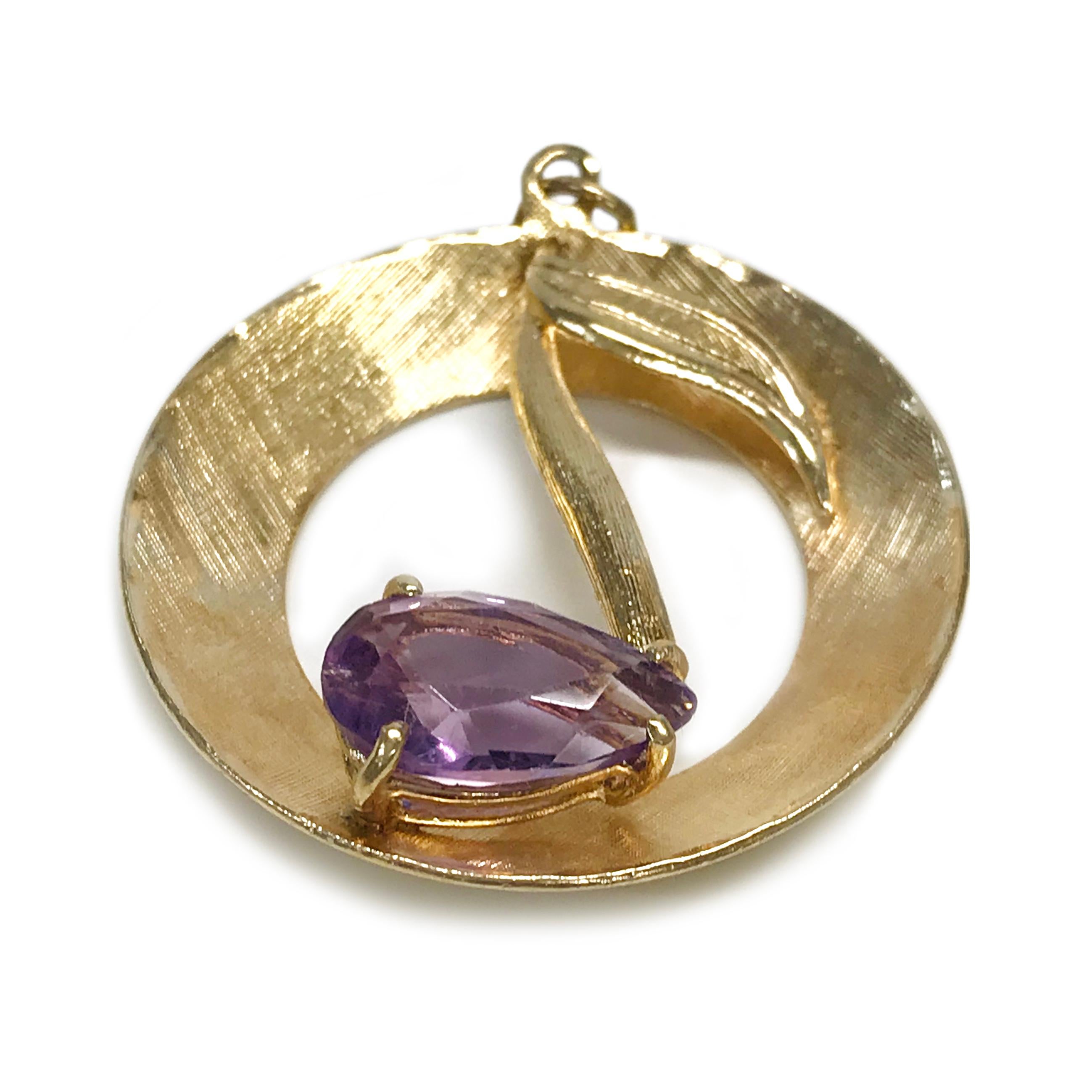 14 Karat Yellow Gold Rembrandt Musical Note Amethyst Pendant. The pendant measures 31.5mm in diameter. The front of the open circle pendant has a satin texture on the front with a musical note in the center. The bottom of the note has a pear-shaped