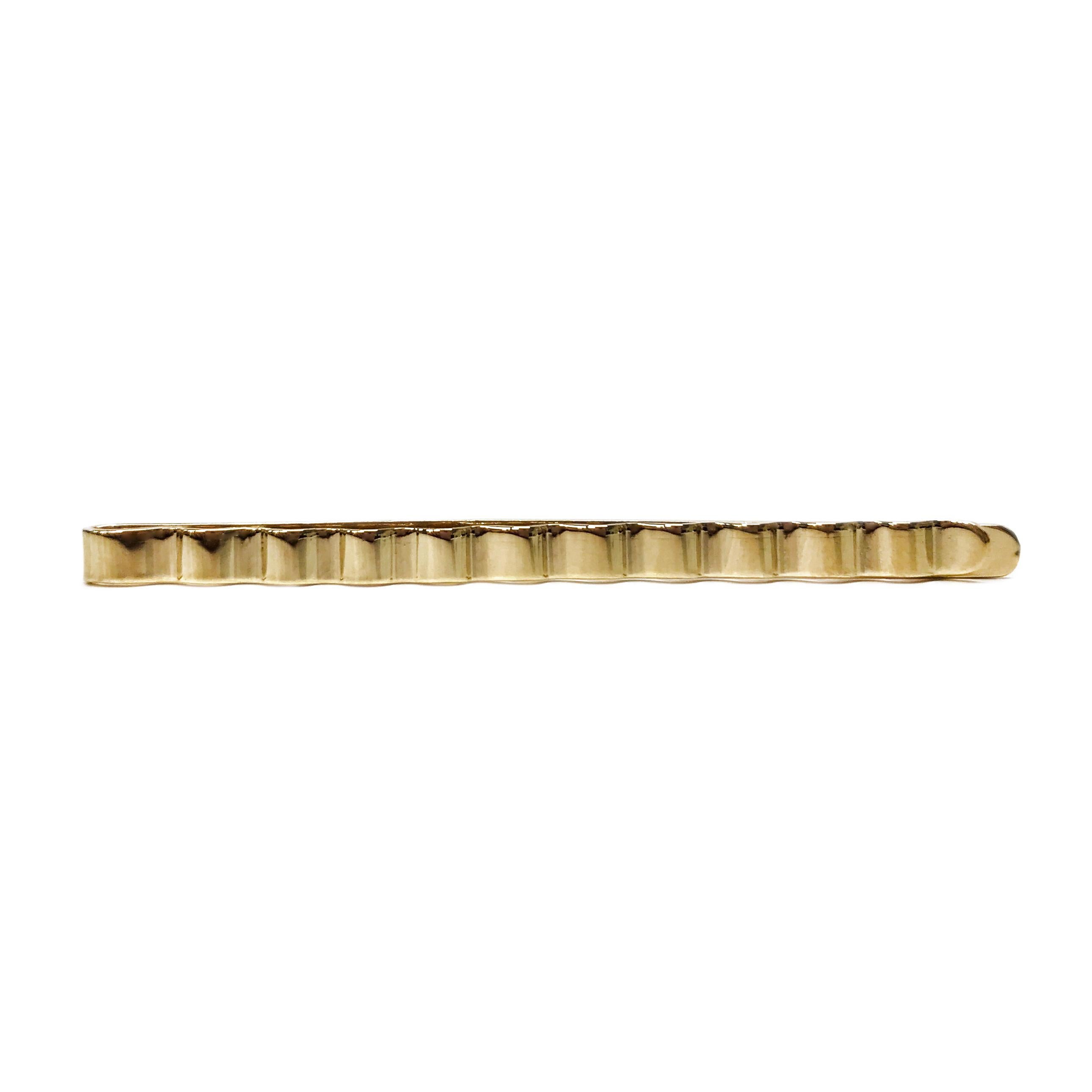 14 Karat Ridged Tie Bar. Simple design yet sophisticated piece that will add a nice detail to any tie. The top of the tie bar has a zig-zag design and the entire tie bar has a smooth shiny. Stamped on the back is 14K. The total weight of the tie