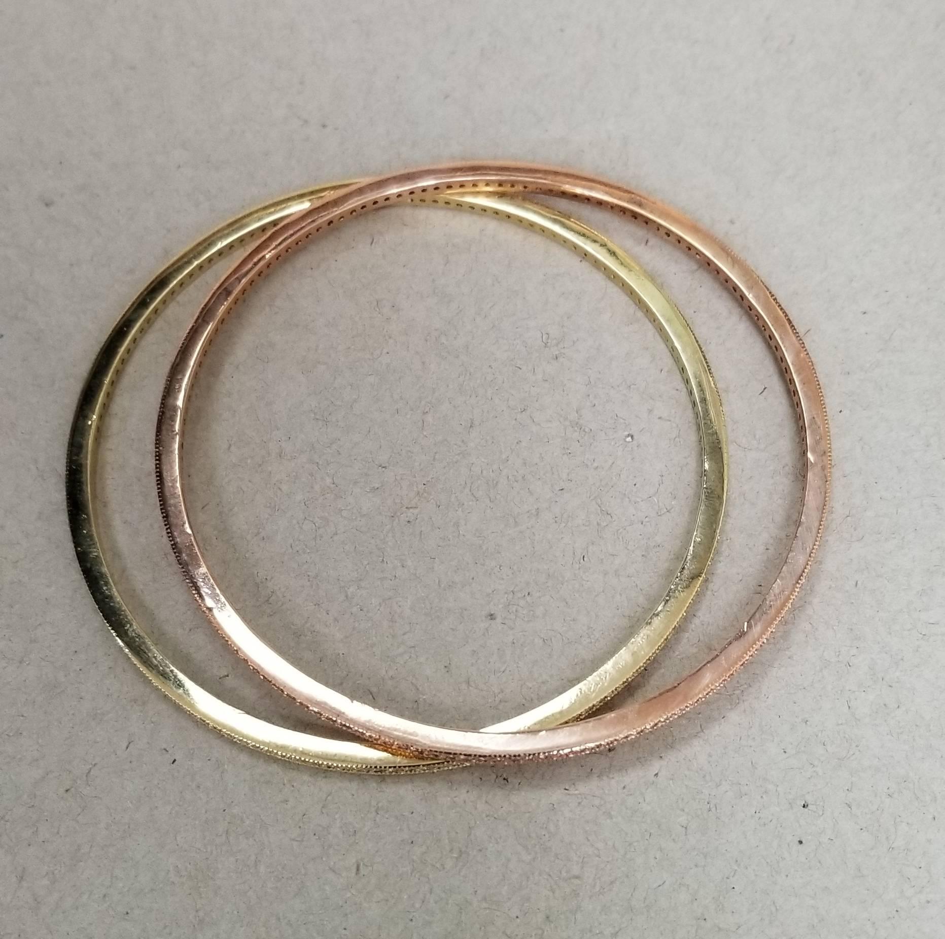 14k rose gold and 14k yellow gold diamond bangle with 142 round full cut diamonds of very fine quality weighing 1.50cts. They are prong set and have milgraining on the sides. 2 Separate bangles with an inside diameter of 2 1/2 inches.  Bangles could